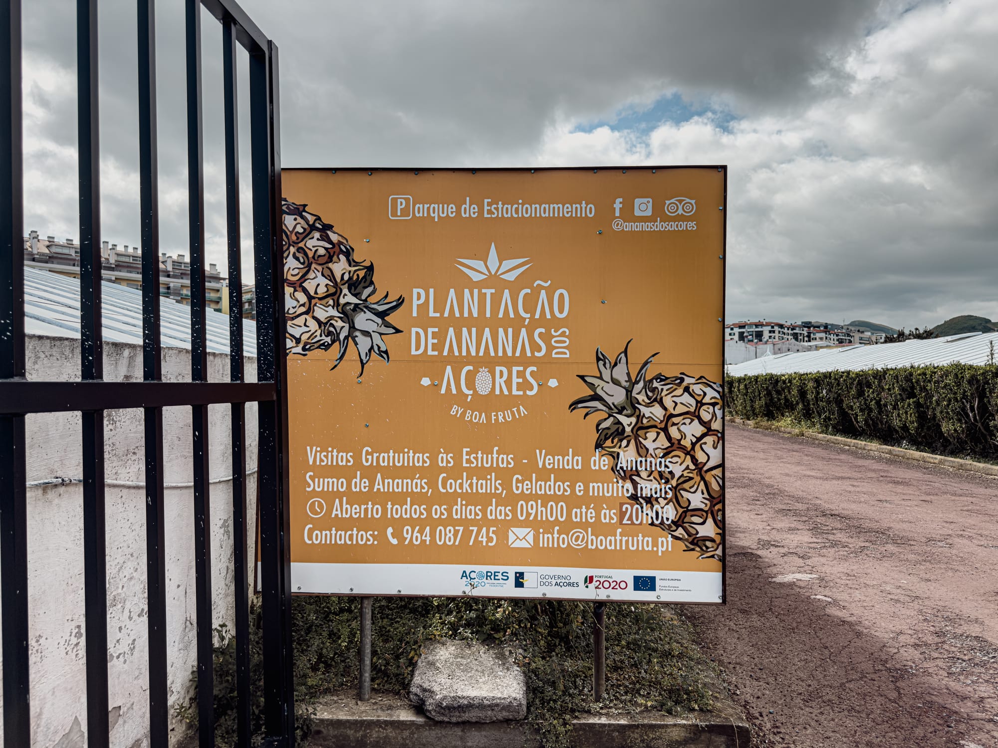 Entrance sign to Plantação de Ananás dos Açores featuring pineapples and visitor information