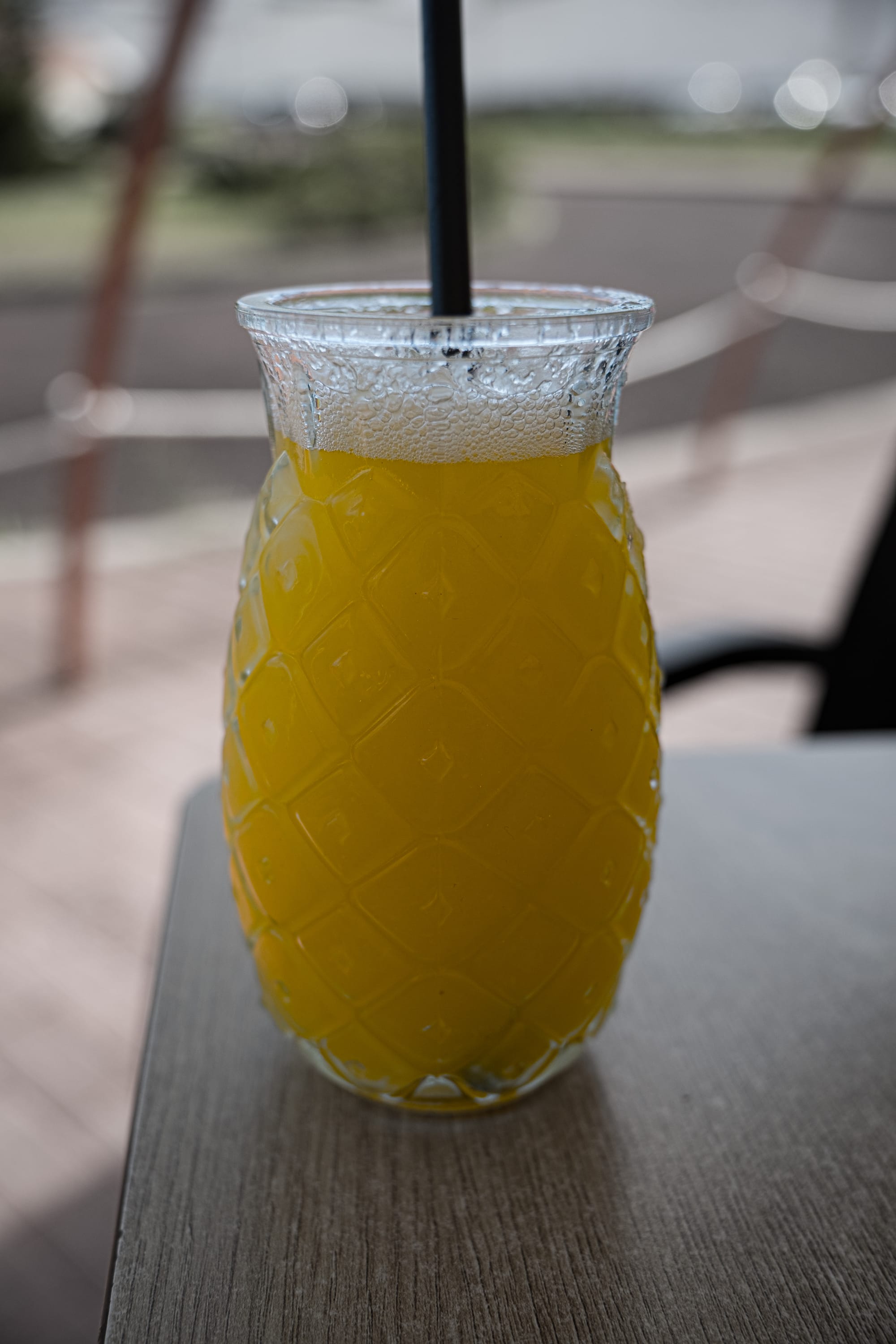 Pineapple-shaped glass filled with fresh pineapple juice at the plantation café
