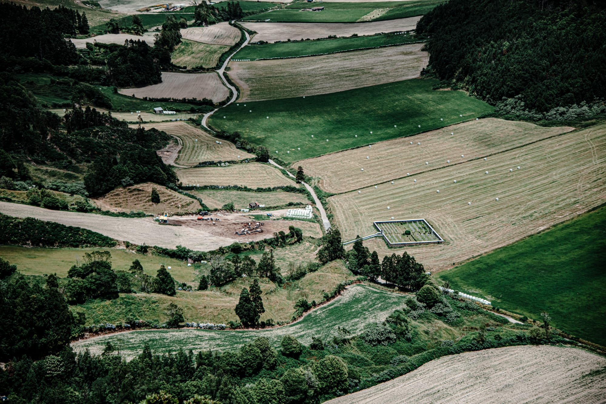 Aerial view of patchwork farmland surrounded by green fields in the Sete Cidades valley, São Miguel Island