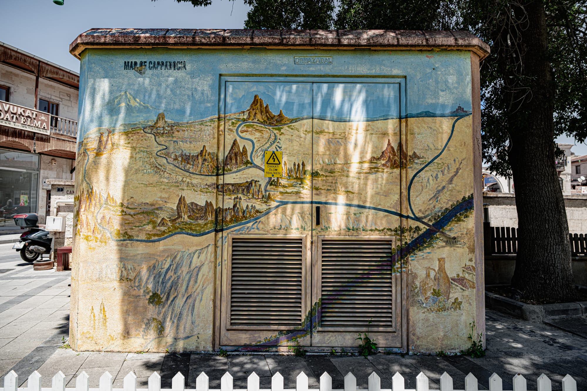 A colorful painted map of Cappadocia on a utility building in Avanos, showing landmarks and valleys