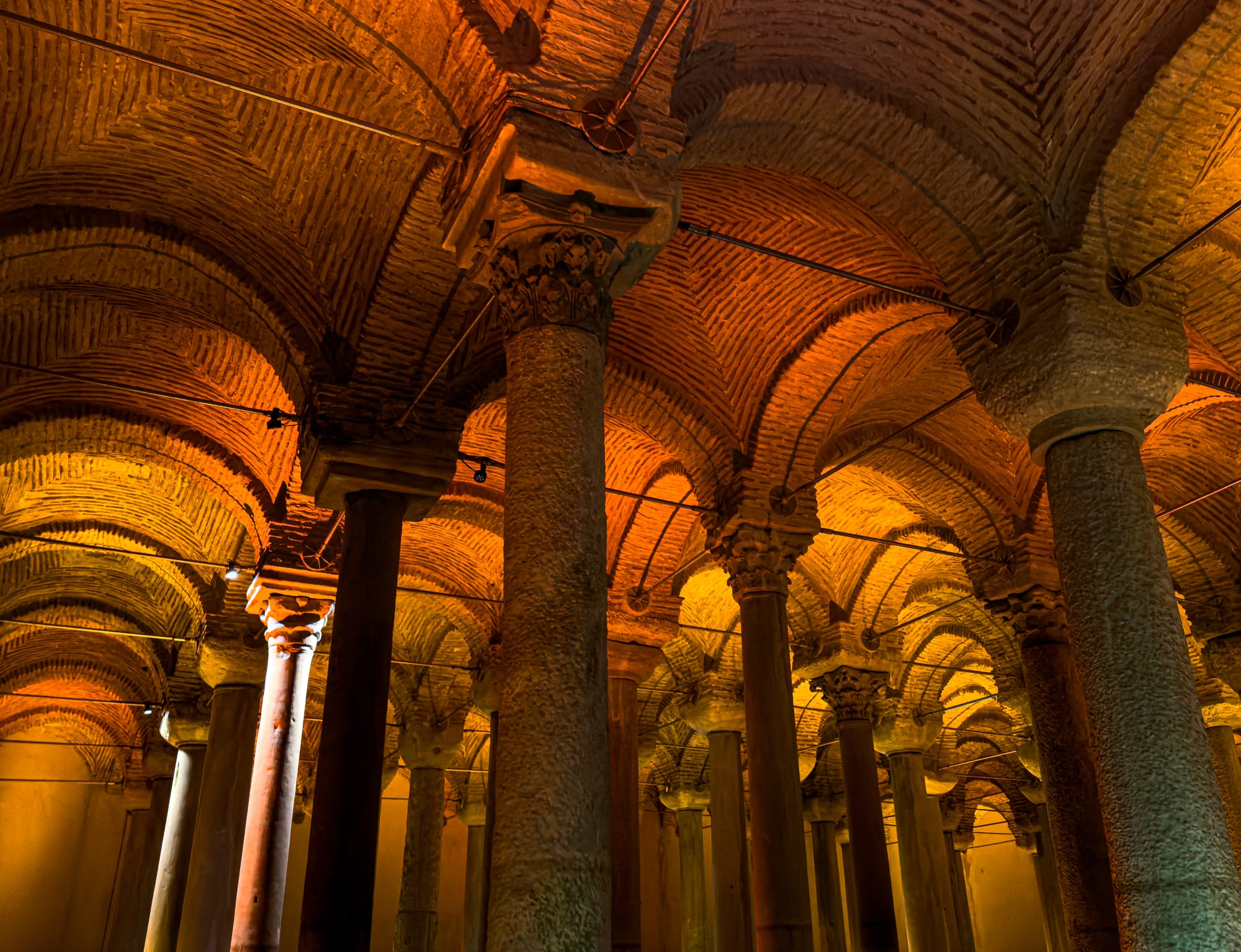 Warmly lit vaulted ceiling and marble columns of the Basilica Cistern in Istanbul