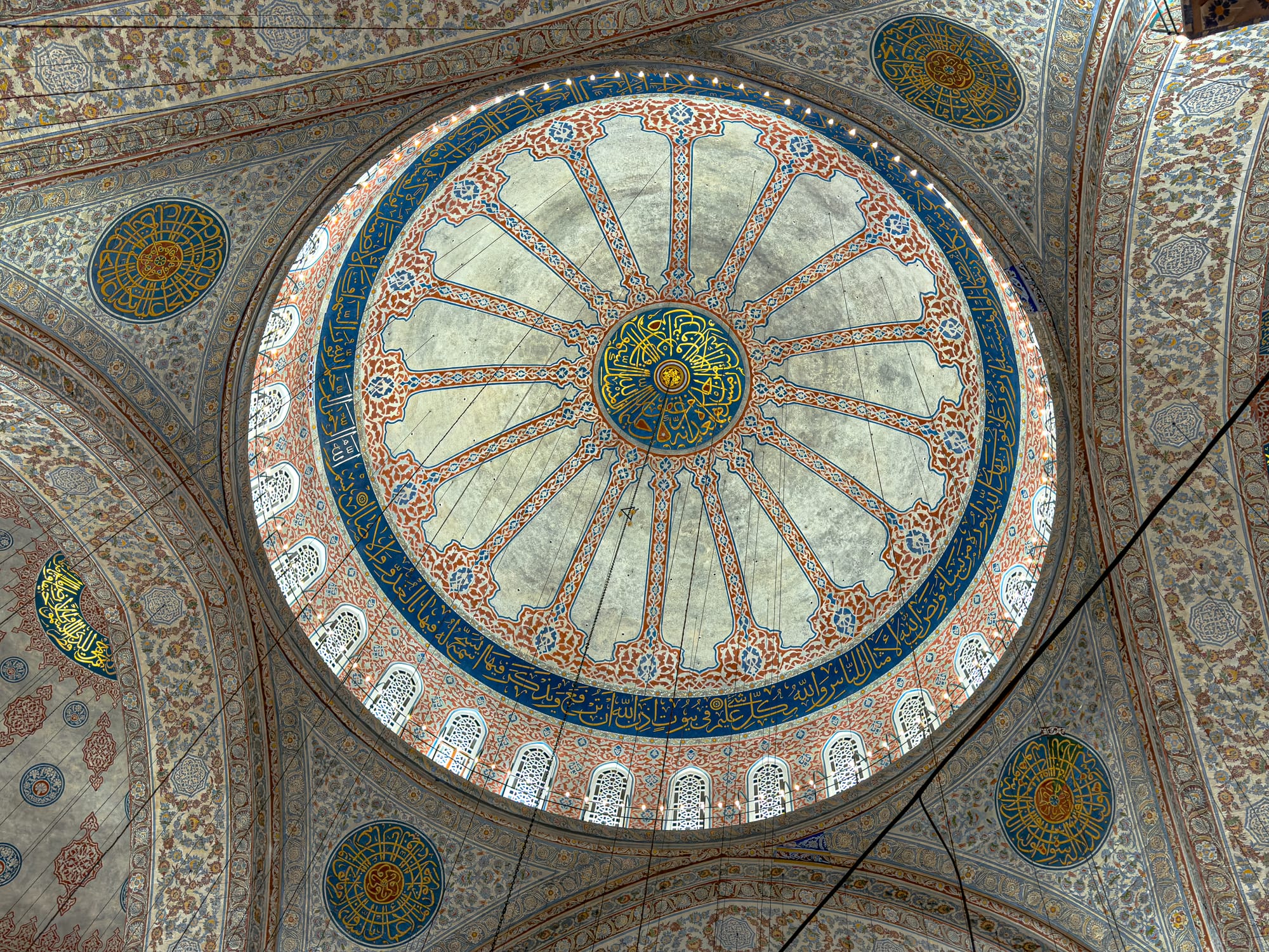 Close-up of the Blue Mosque’s central dome, adorned with floral motifs and Arabic calligraphy