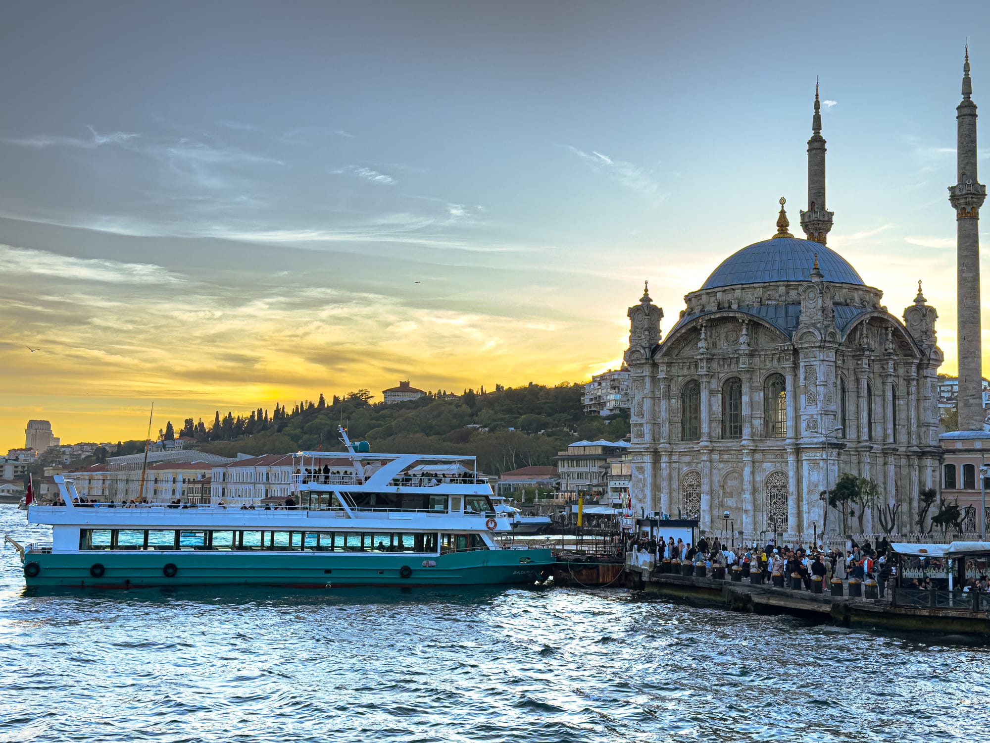 Bosphorus ferry docked near the Ortaköy Mosque at sunset in Istanbul