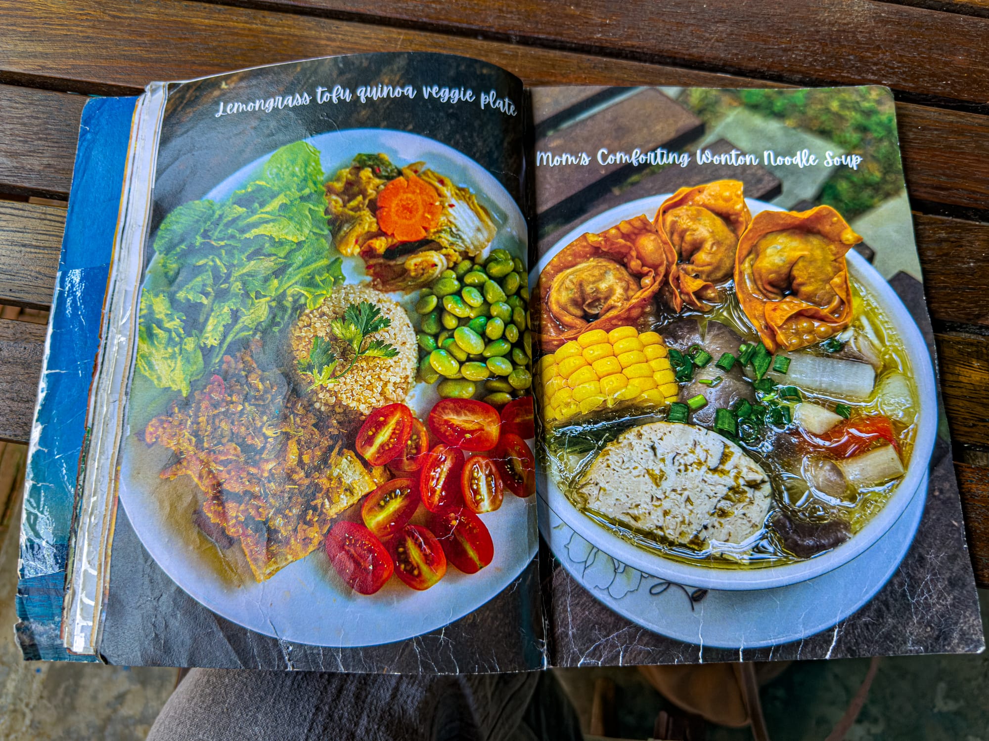 Open menu at Chickpea Eatery in Hội An showing a vegan lemongrass tofu quinoa veggie plate with rice, fresh greens, cherry tomatoes, edamame, and a bowl of comforting wonton noodle soup with corn, mushrooms, tofu, and crispy wontons