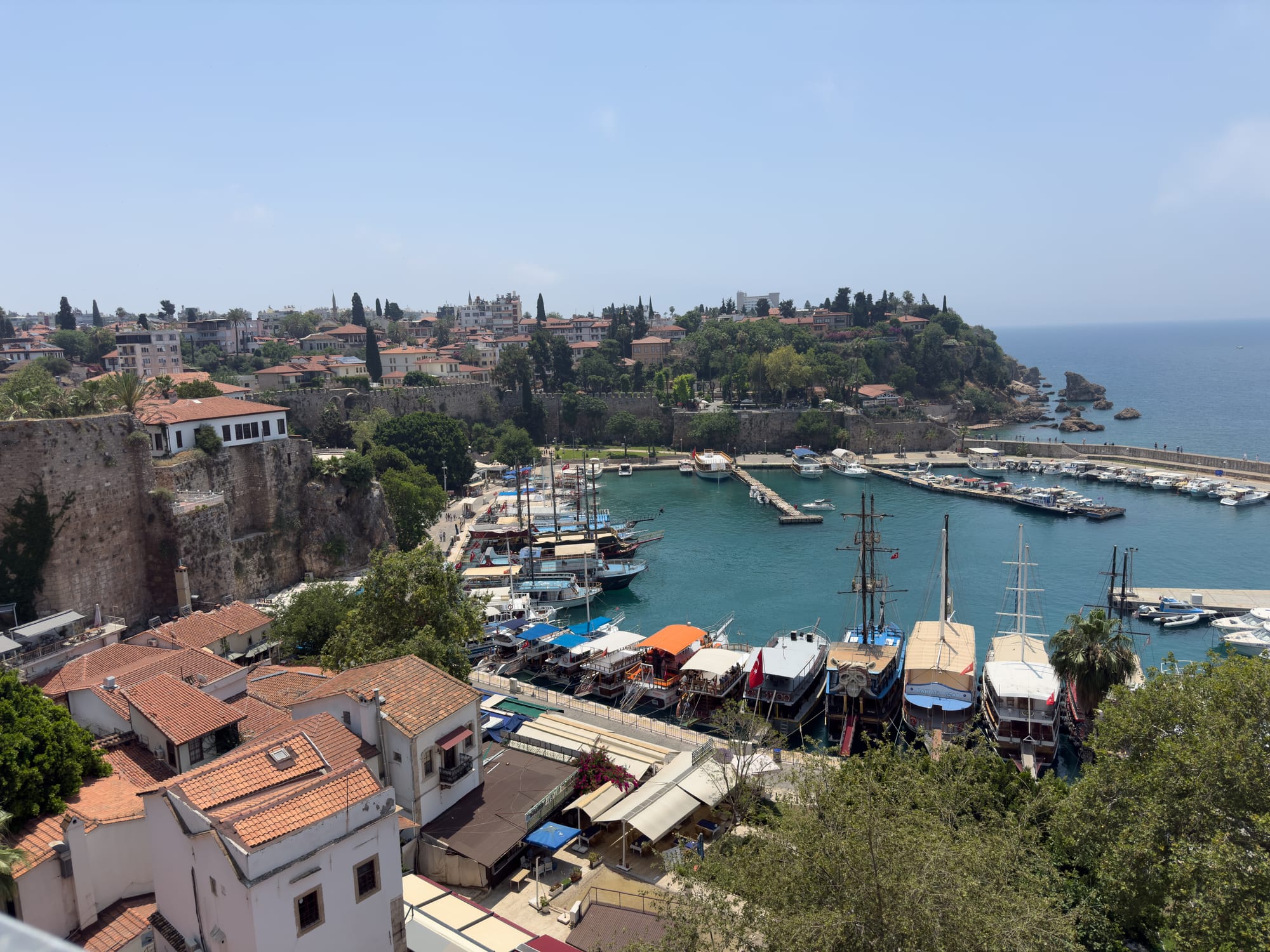 View of Antalya’s marina with moored sailboats and terracotta rooftops, located directly beside Coworking Antalya