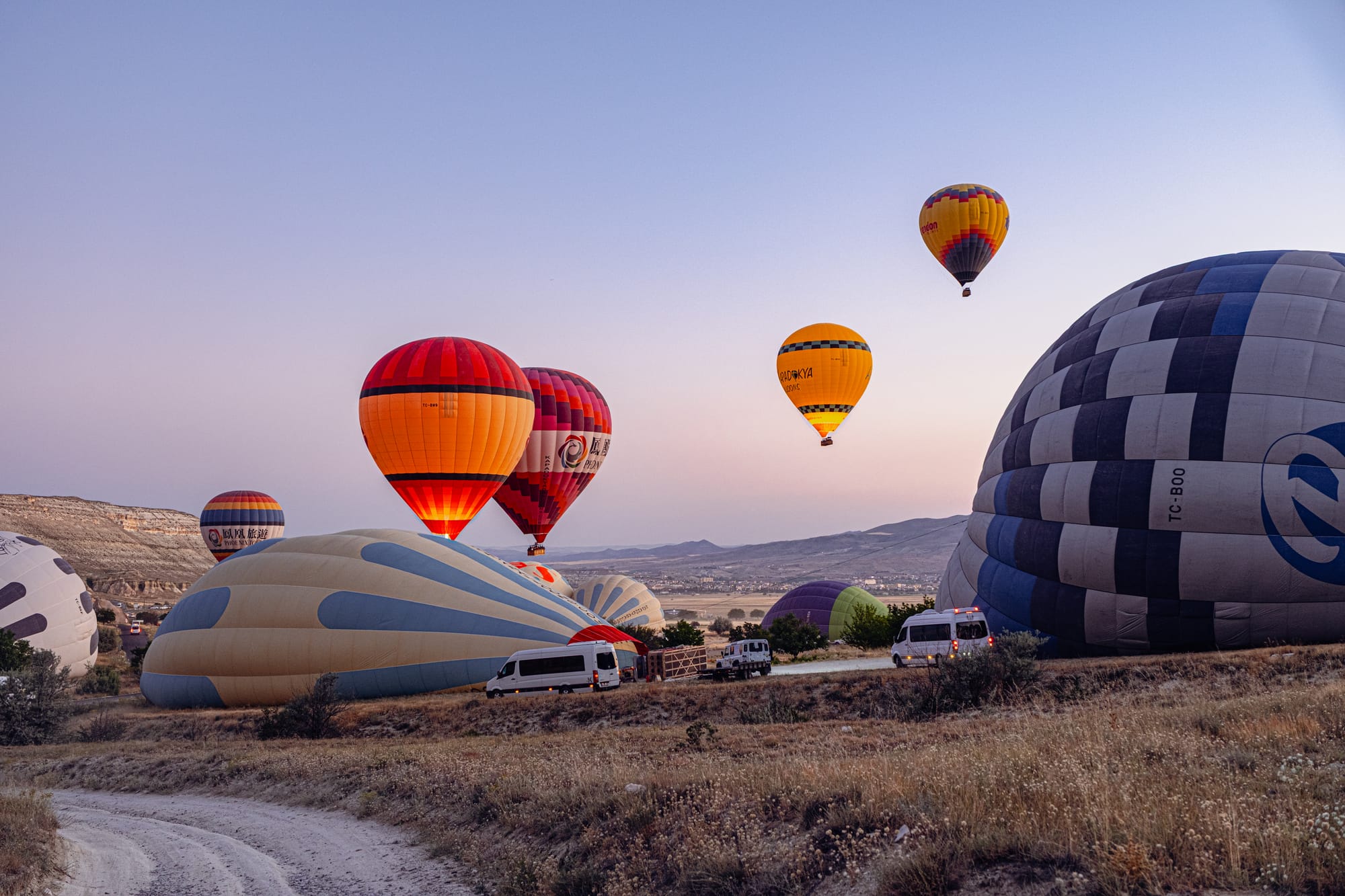 Hot air balloons being inflated and launched at sunrise in Cappadocia, Turkey