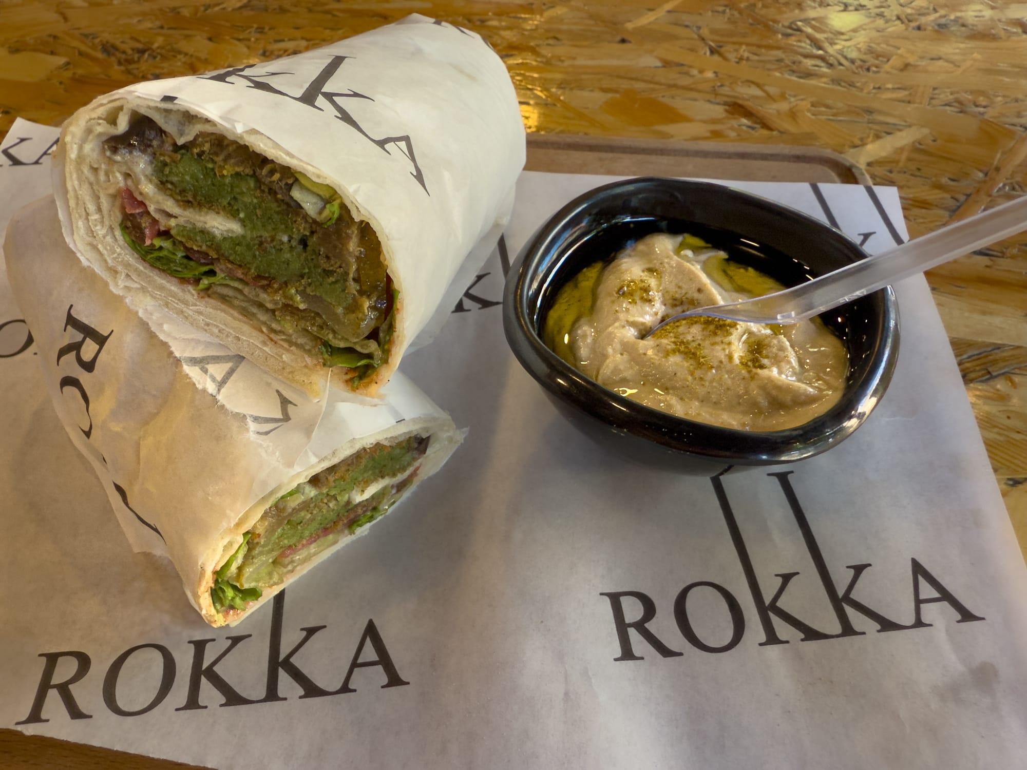 Close-up of a falafel and eggplant wrap served with tahini sauce at Rokka, a vegan-friendly cafe in Antalya’s city center