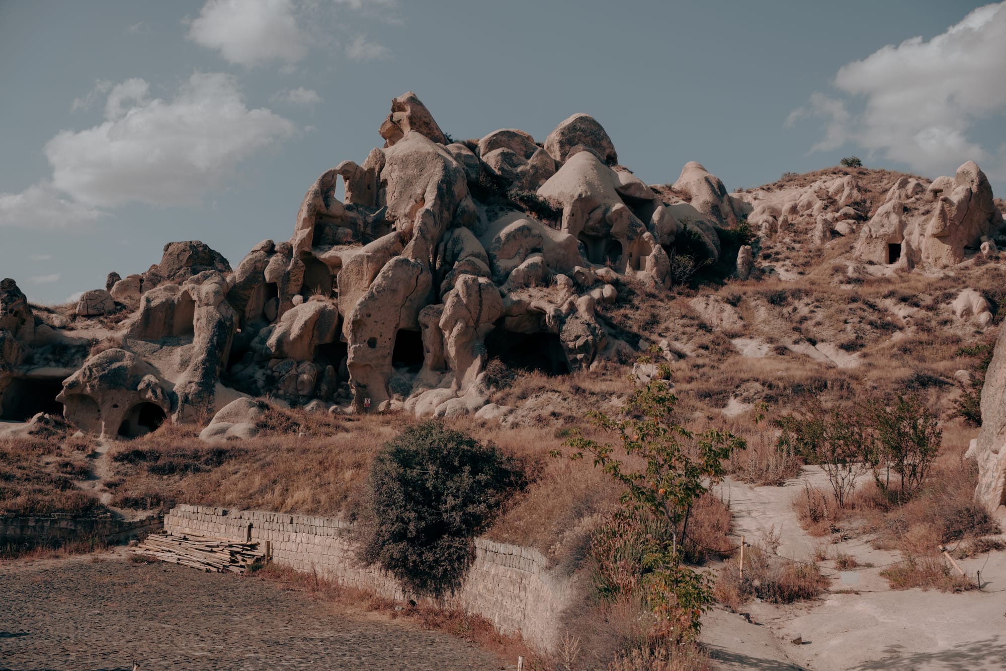 Rock formations with multiple carved cave entrances and dwellings at Göreme Open Air Museum in Cappadocia