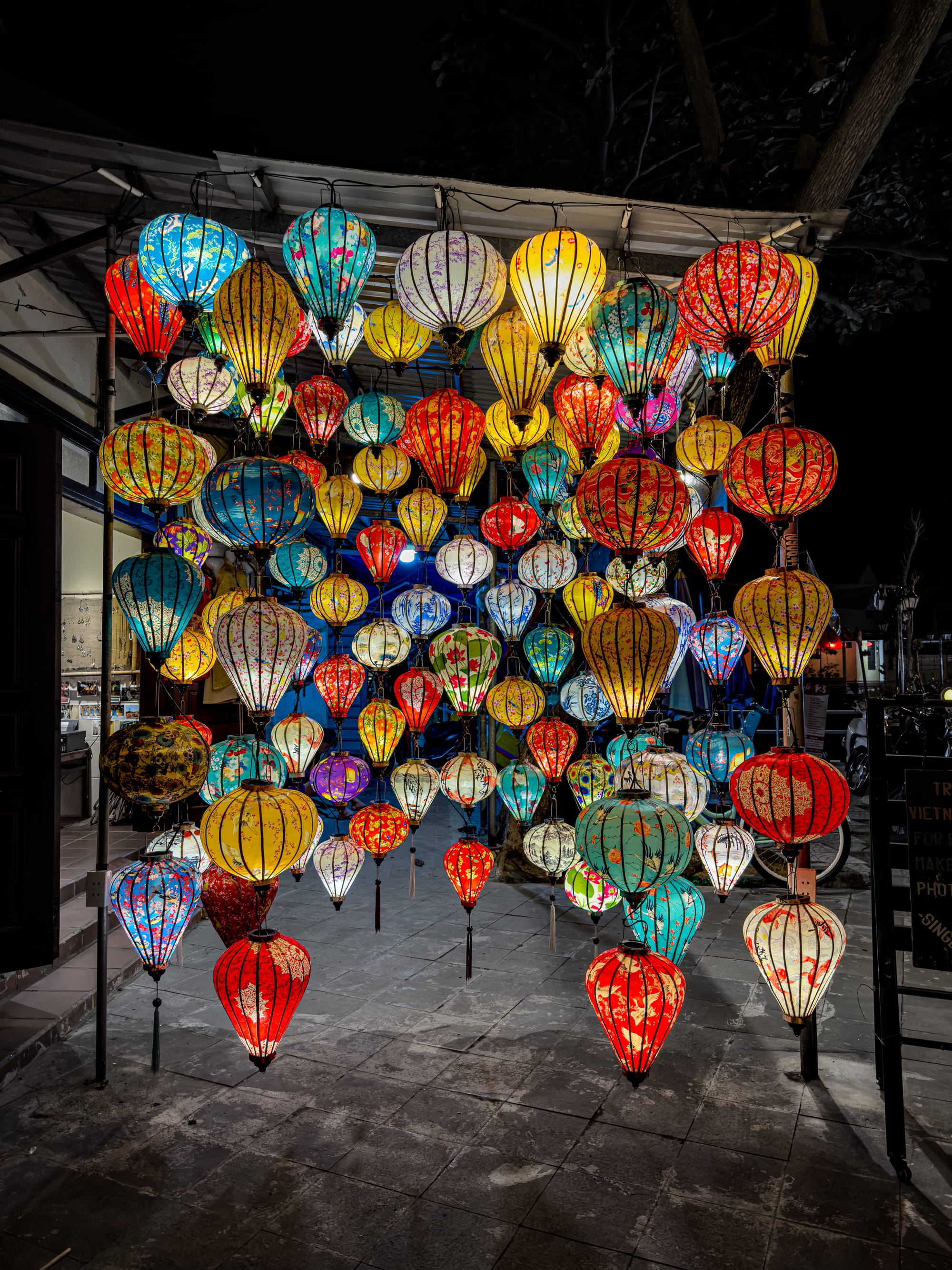 Colorful silk lanterns glowing at night in Hội An’s Old Town, Vietnam, illuminating the streets with traditional handmade craft and creating the town’s signature night-time charm