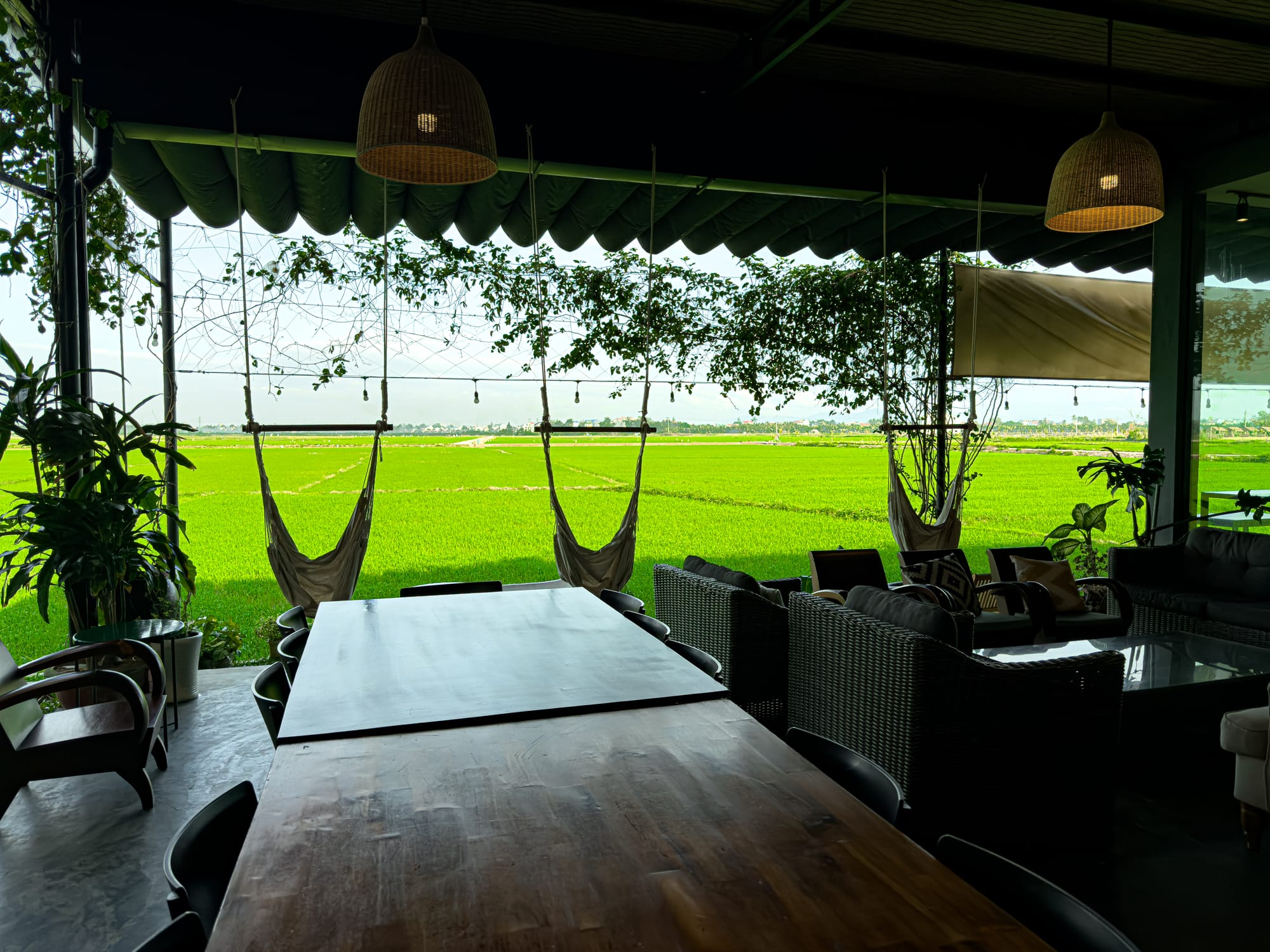 Hub Hoi An coworking space in Vietnam with hammocks, digital nomad seating, and panoramic rice field views
