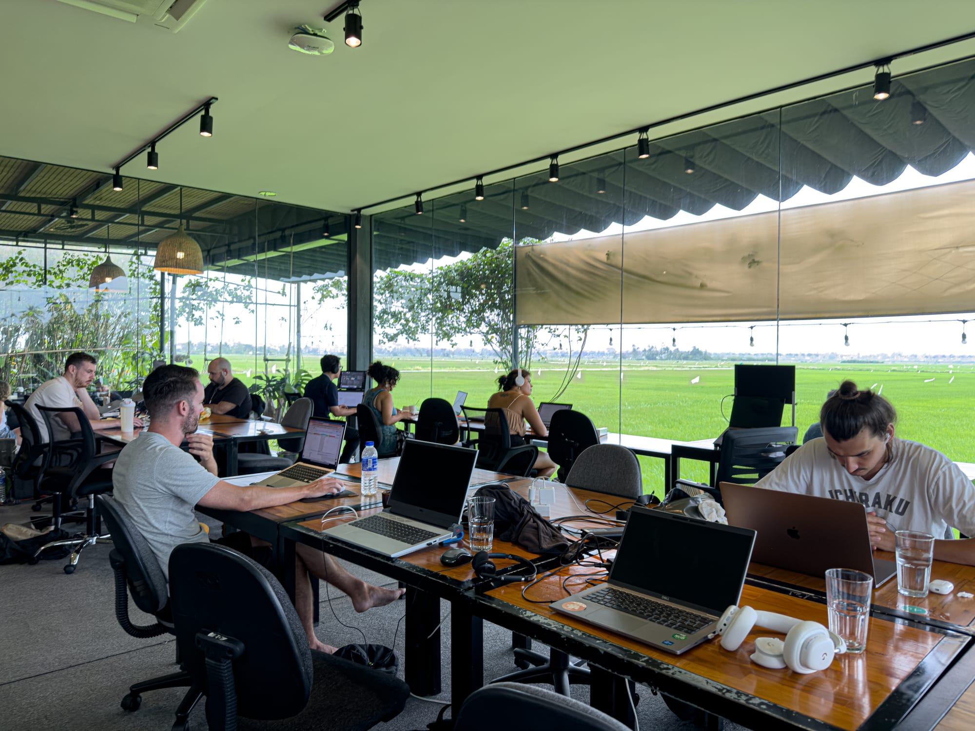 Hub Hoi An coworking space in Vietnam with digital nomads, remote working desks, panoramic rice field views