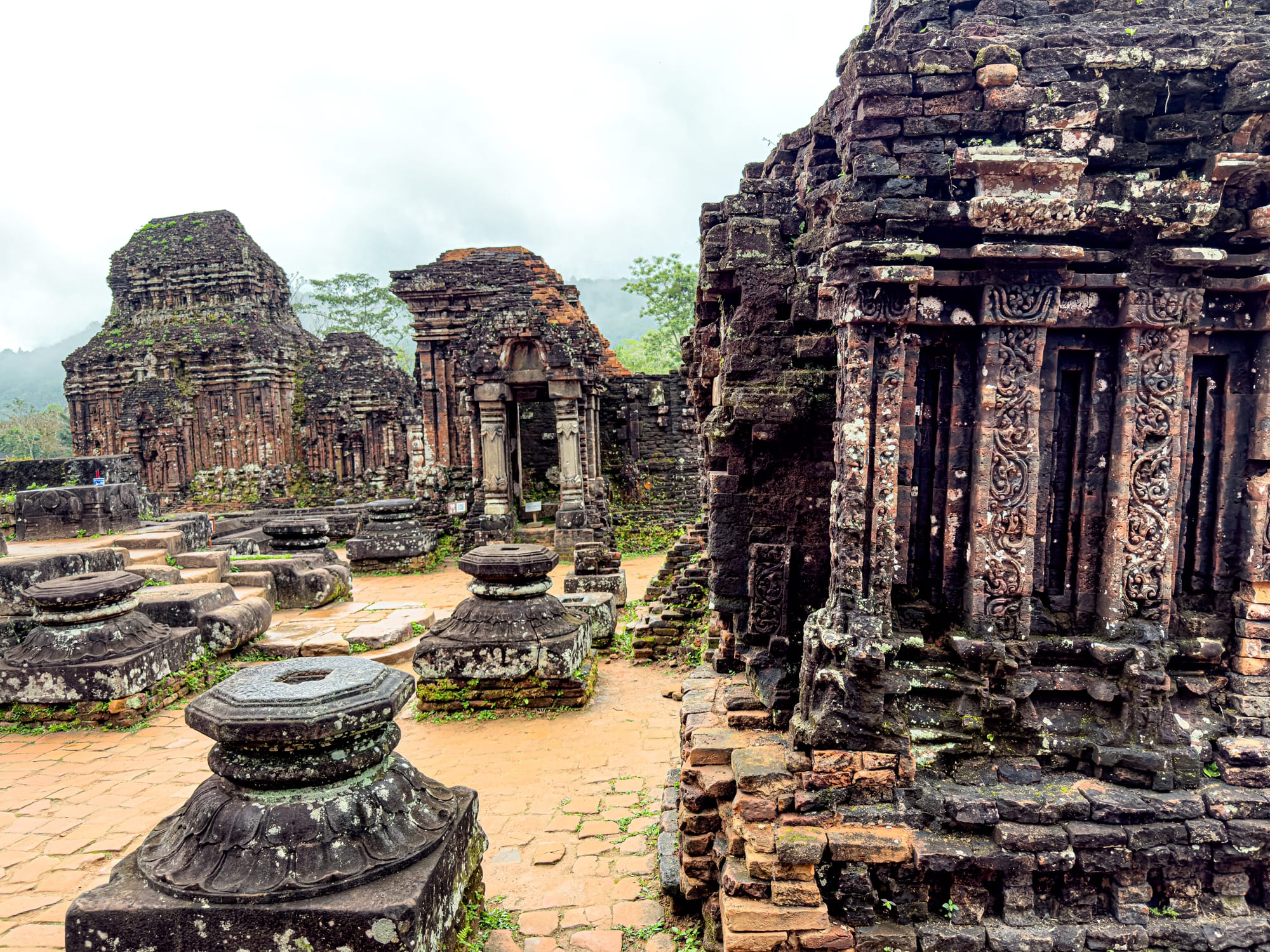 Stone temple foundations and detailed carvings at Mỹ Sơn Sanctuary Cham ruins UNESCO site near Hội An, Vietnam