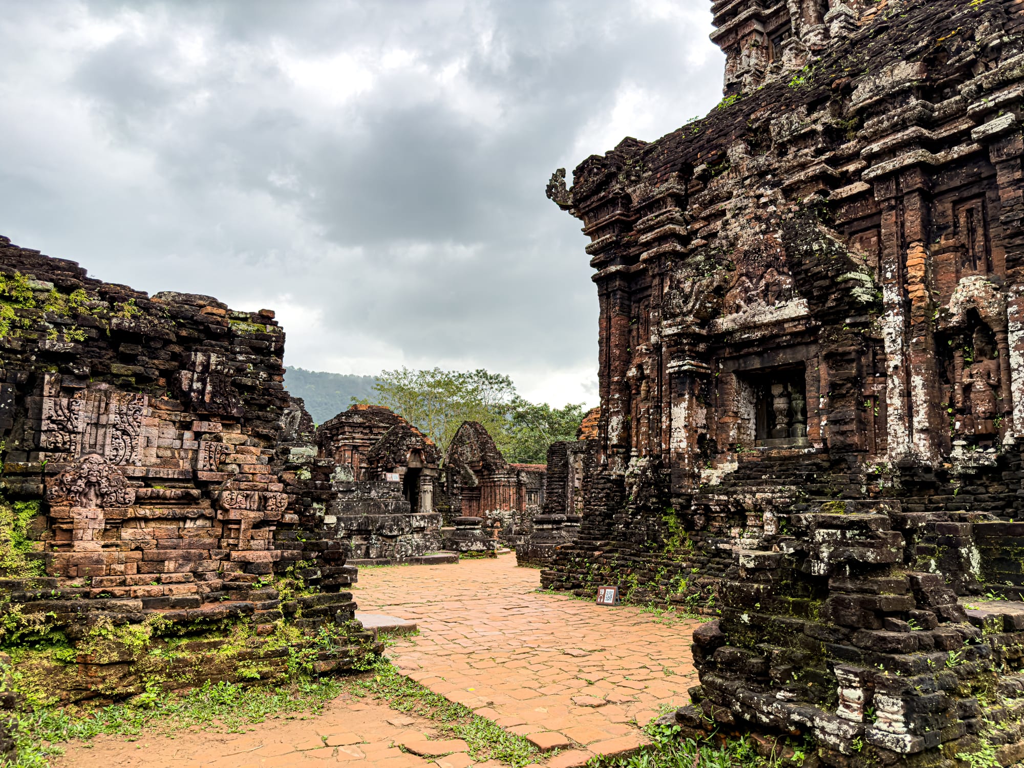 Cham temple ruins with detailed carvings and stone walls at Mỹ Sơn Sanctuary UNESCO site in Vietnam