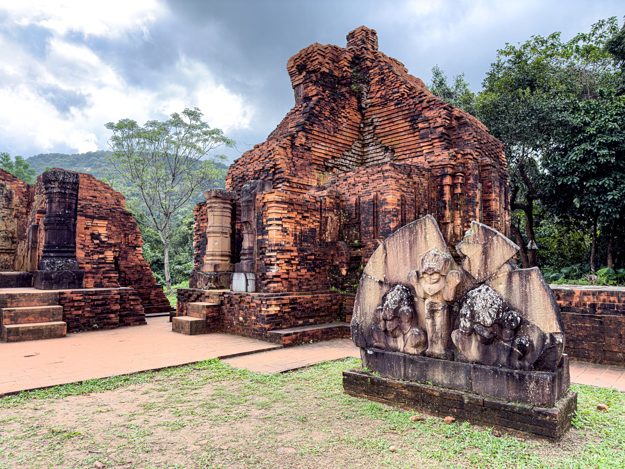 Ancient Cham brick temple with stone deity carvings at Mỹ Sơn Sanctuary UNESCO World Heritage site in Vietnam