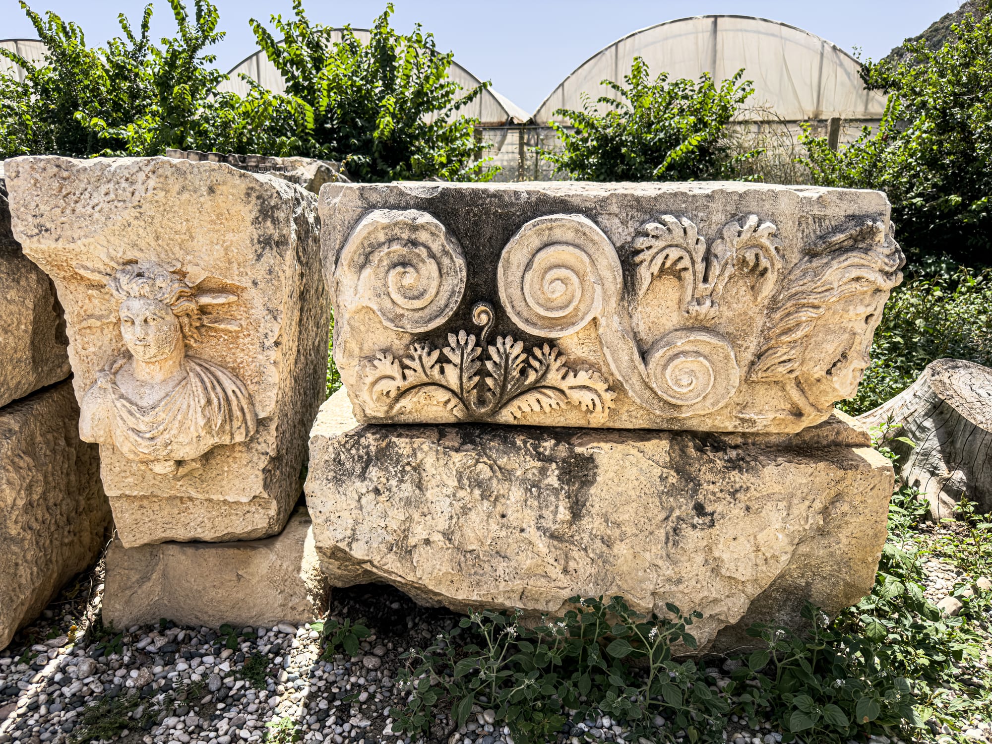 Carved limestone fragments with botanical motifs and mythic faces from ancient Lycian city of Myra in Demre, Turkey