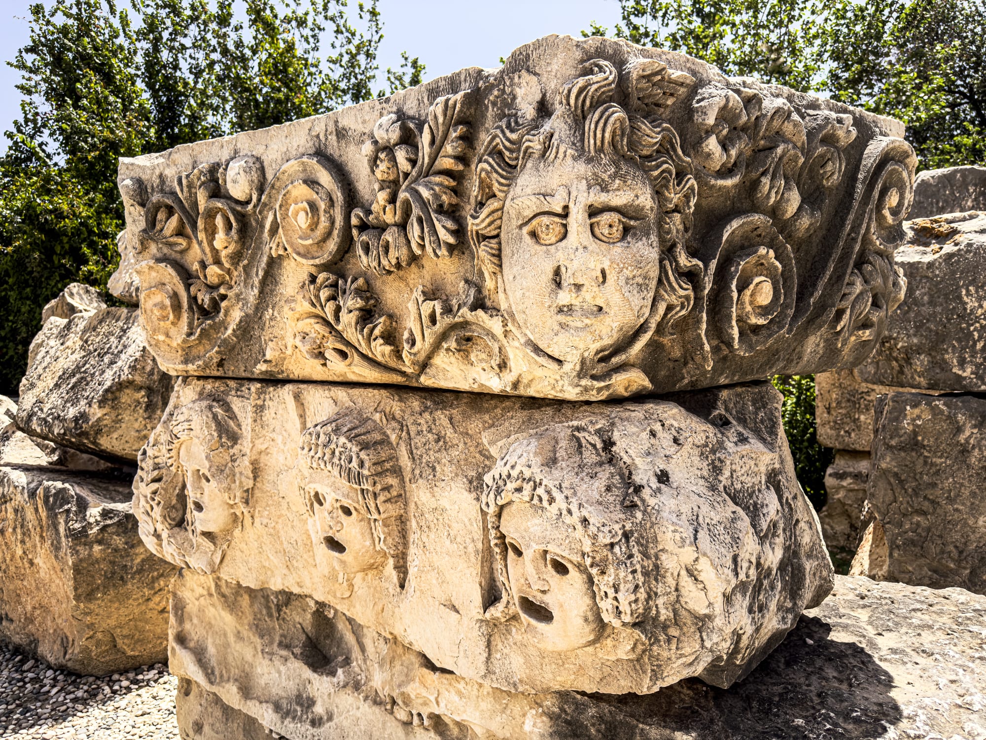 Relief sculpture of Medusa and dramatic masks from ancient Myra, part of Lycian ruins in Demre, Turkey