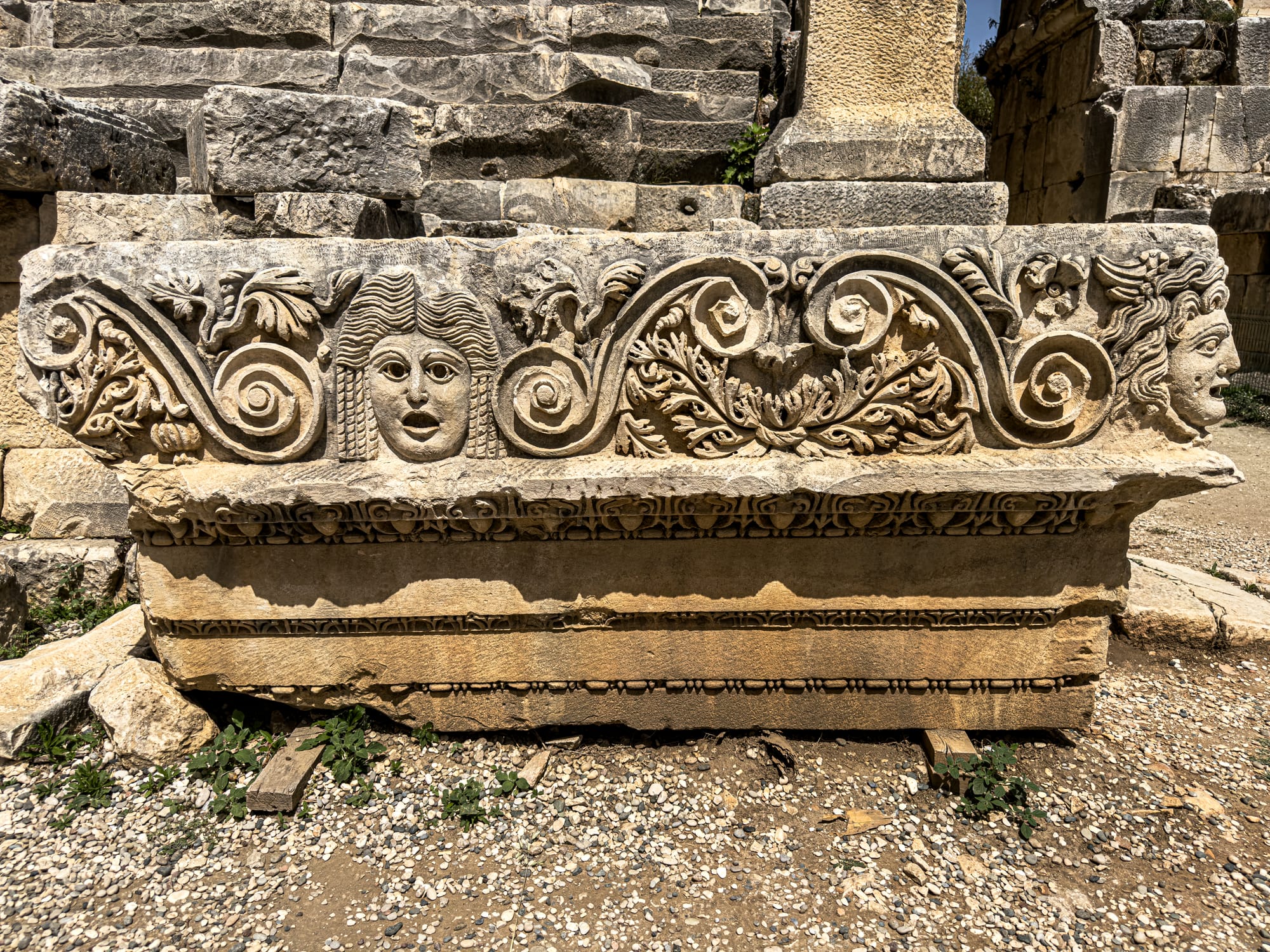 Detailed Roman frieze with theatrical faces and scroll carvings at Myra ancient city near Demre, Antalya