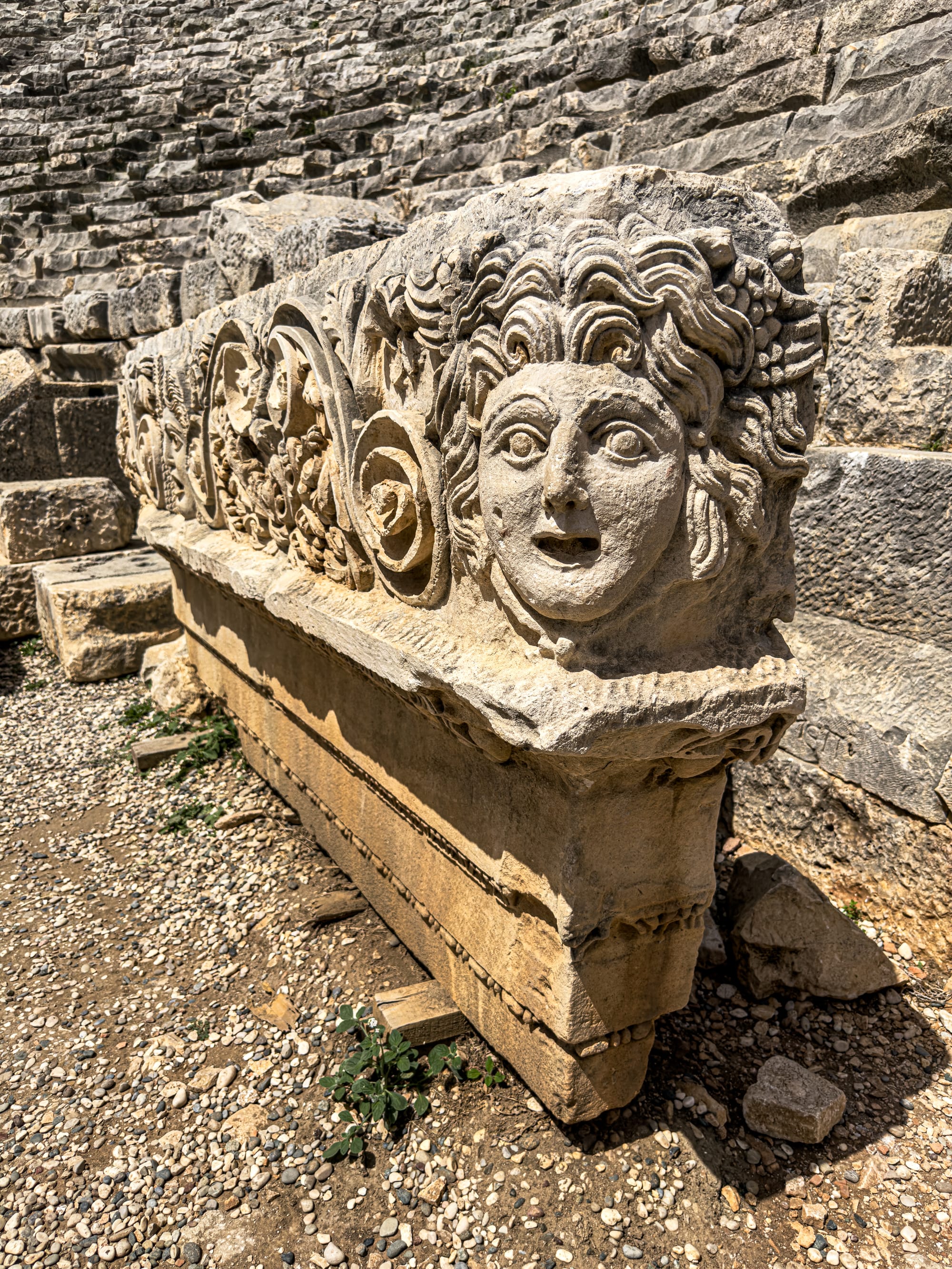 Detailed stone frieze from Myra’s Roman theater featuring a theatrical mask, acanthus leaves, and ornate scrollwork from Lycian-Roman architecture