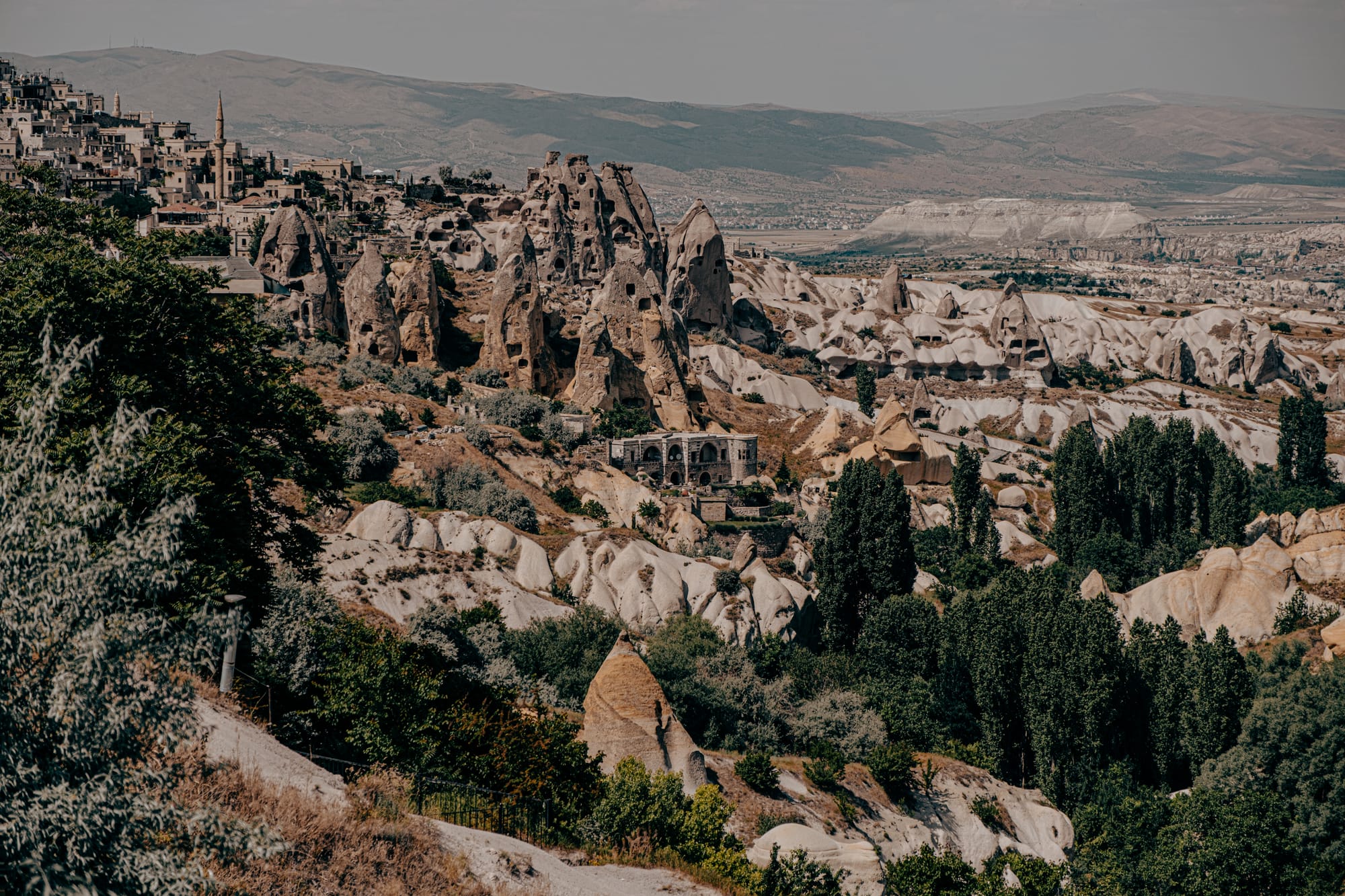 Panoramic view of Uçhisar Castle surrounded by fairy chimneys and rock formations in Cappadocia