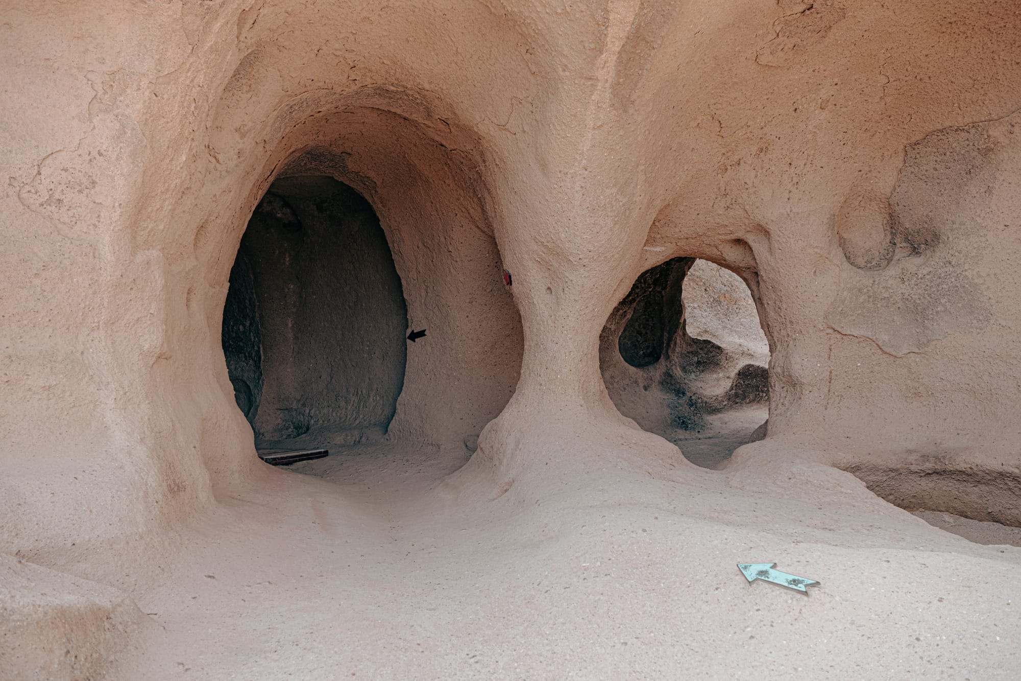 Cave entrances and passageways carved into soft volcanic rock at Selime Monastery in Cappadocia