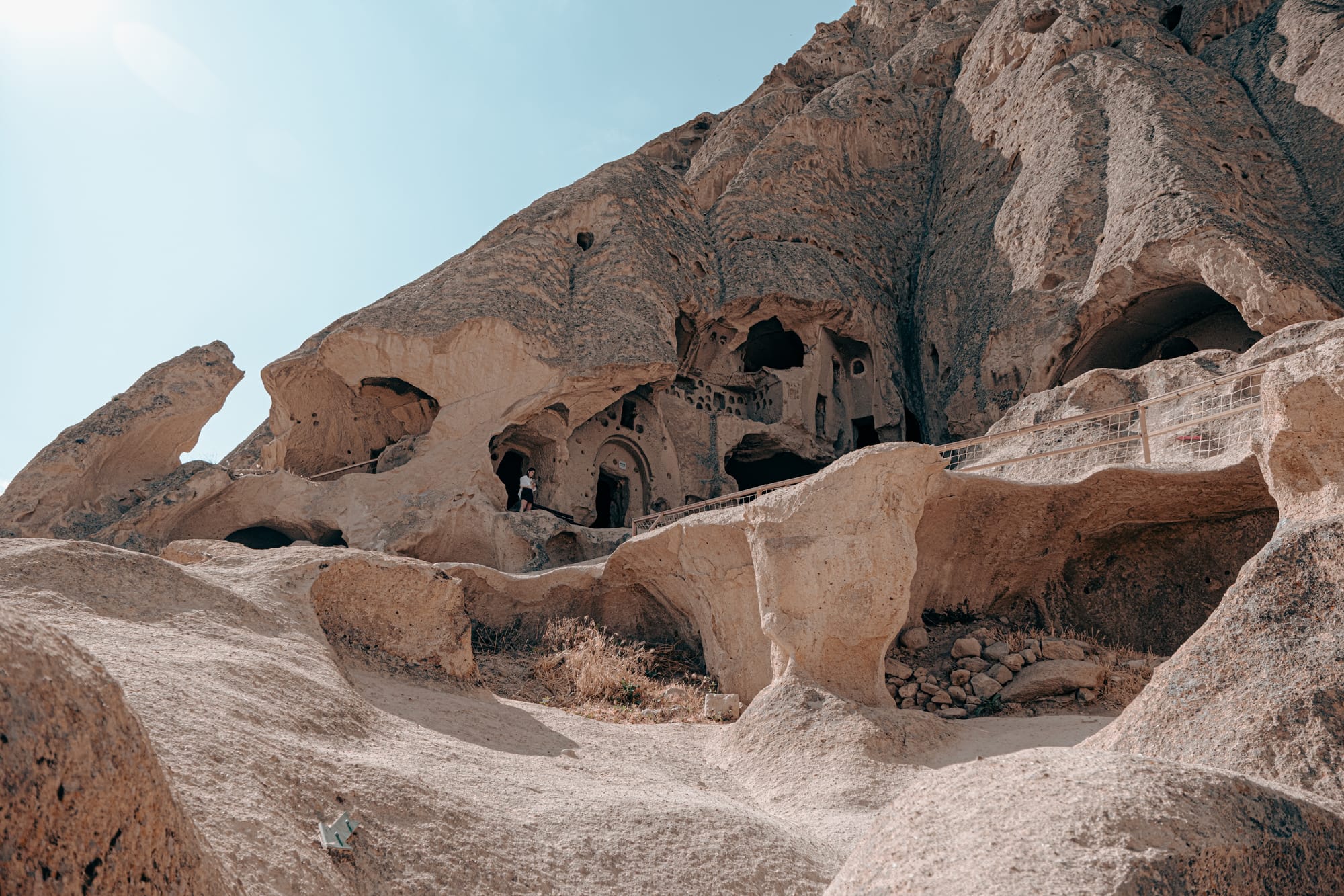 Rock-cut entrance and facade of Selime Monastery in Cappadocia with intricate cave openings and pathways