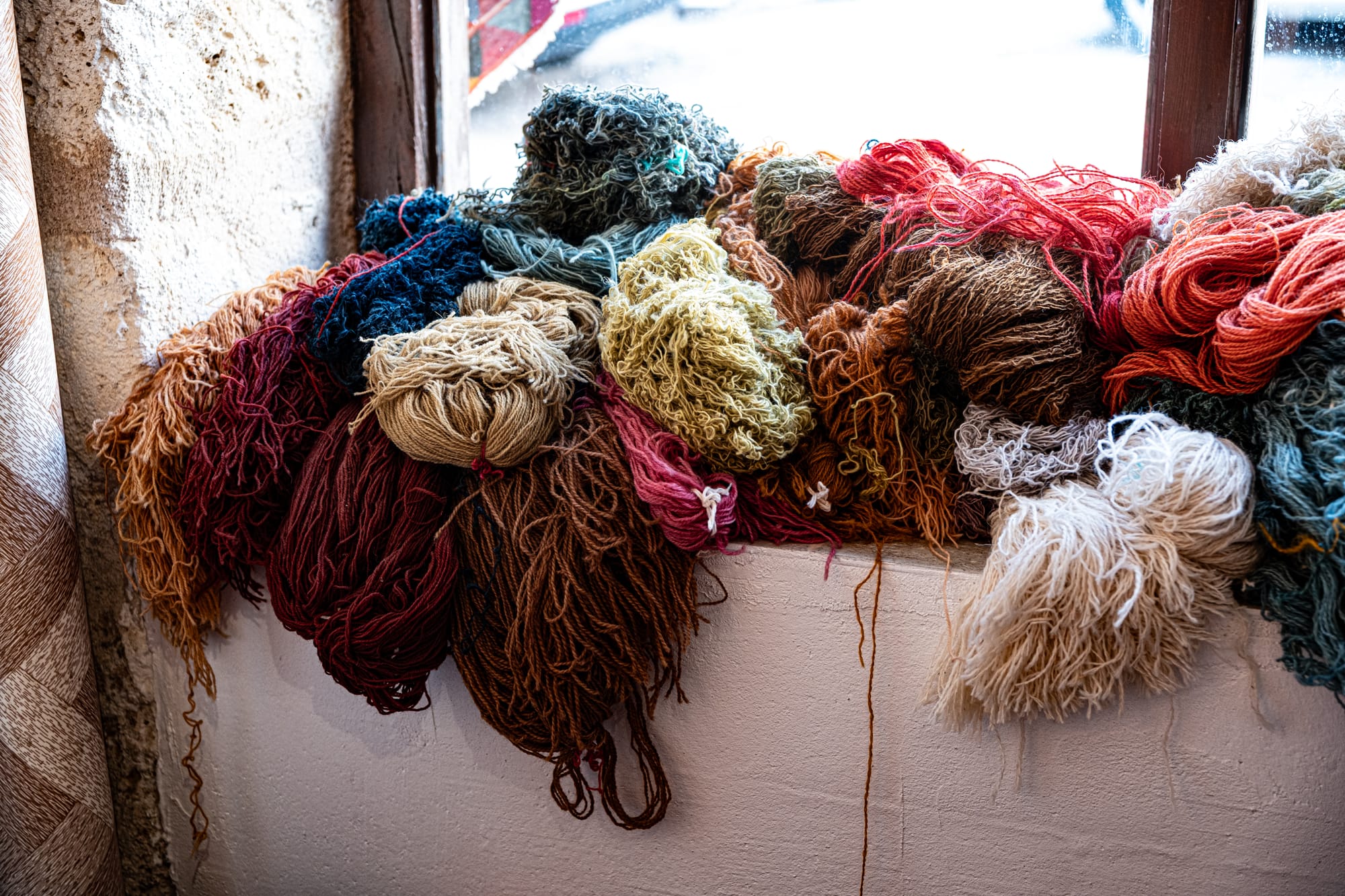 Uçhisar Cappadocia close up of colorful wool yarn bundles used for traditional carpet weaving