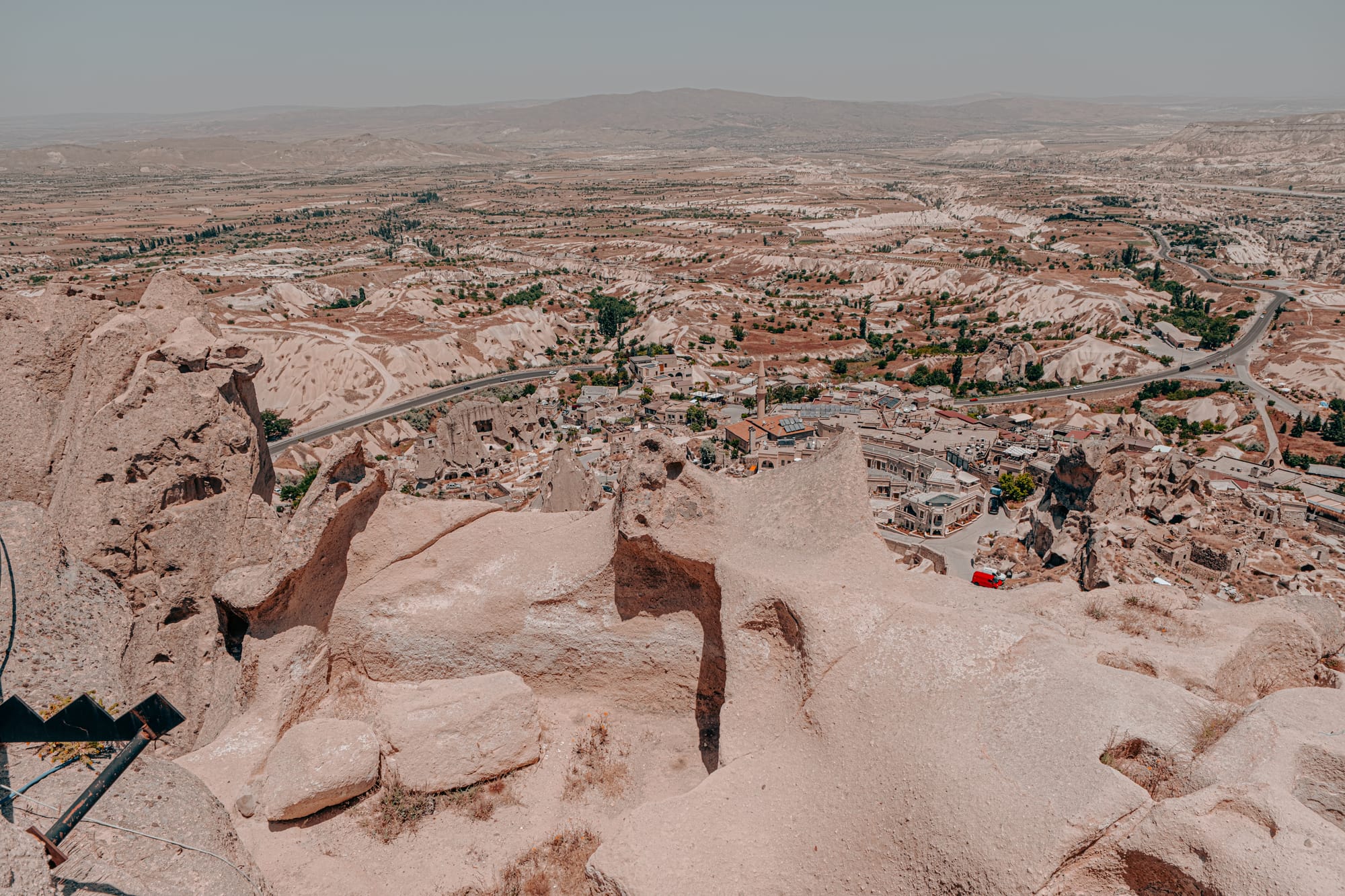 Uçhisar Castle Cappadocia summit view overlooking the town, surrounding valleys, and distant mountains