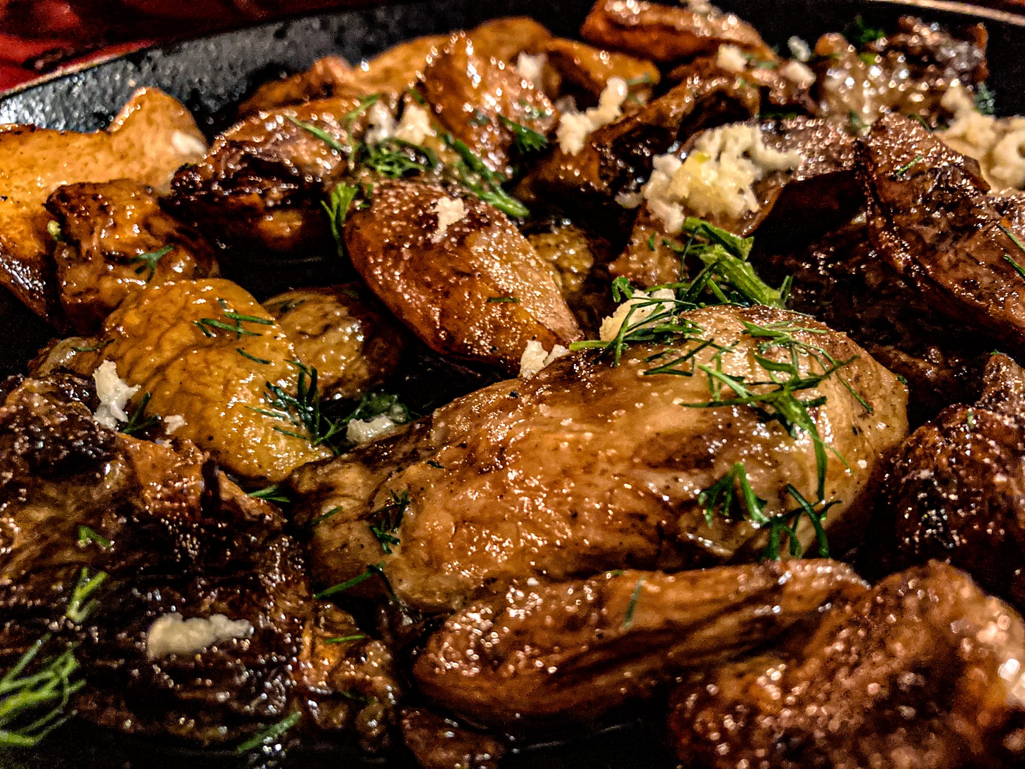 Close-up of Bulgarian porcini mushrooms sautéed in olive oil, garnished with fresh dill and minced garlic