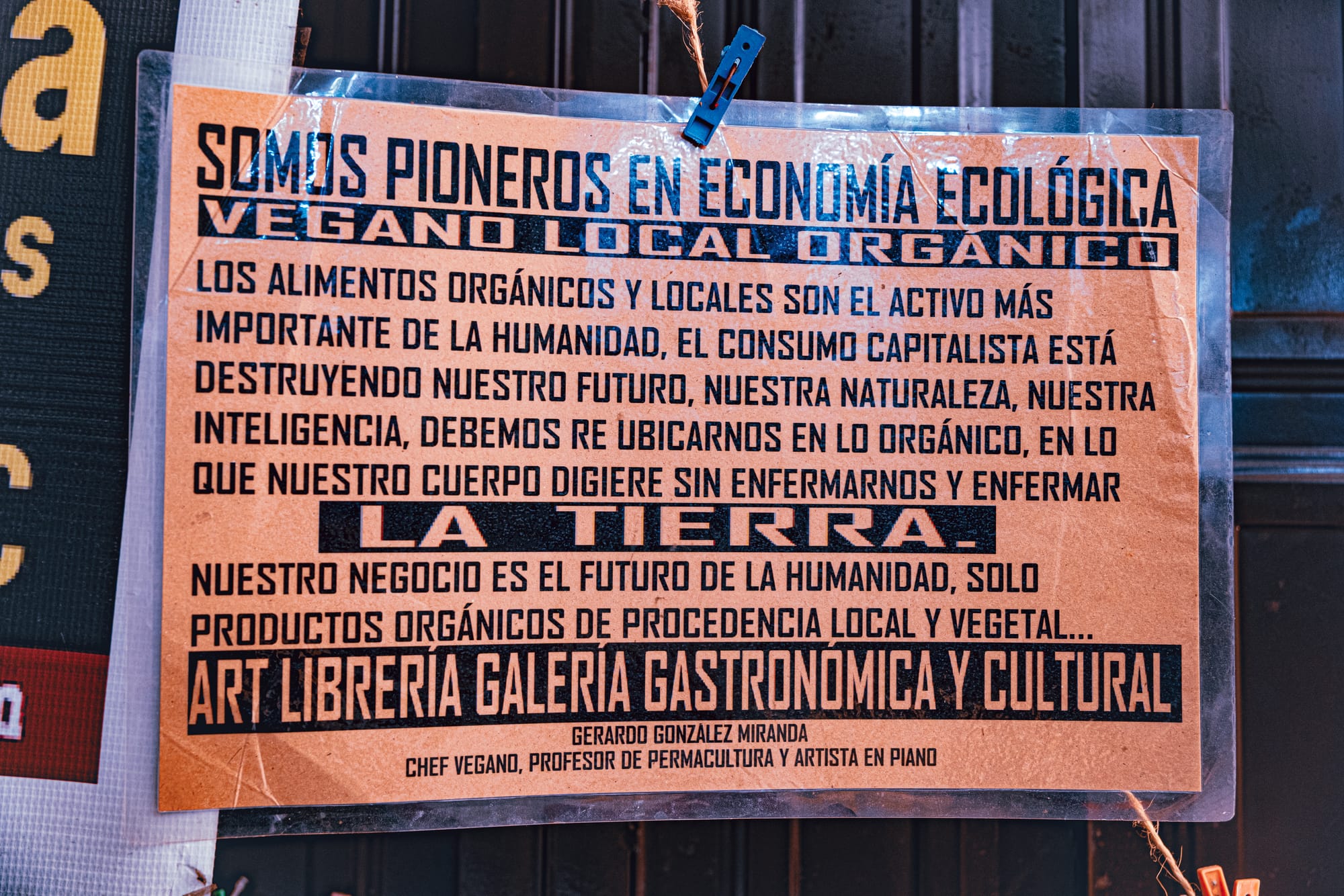 A sign at Art Libreria in San Cristóbal de las Casas describing its ecological vegan philosophy, promoting local organic food and sustainable practices