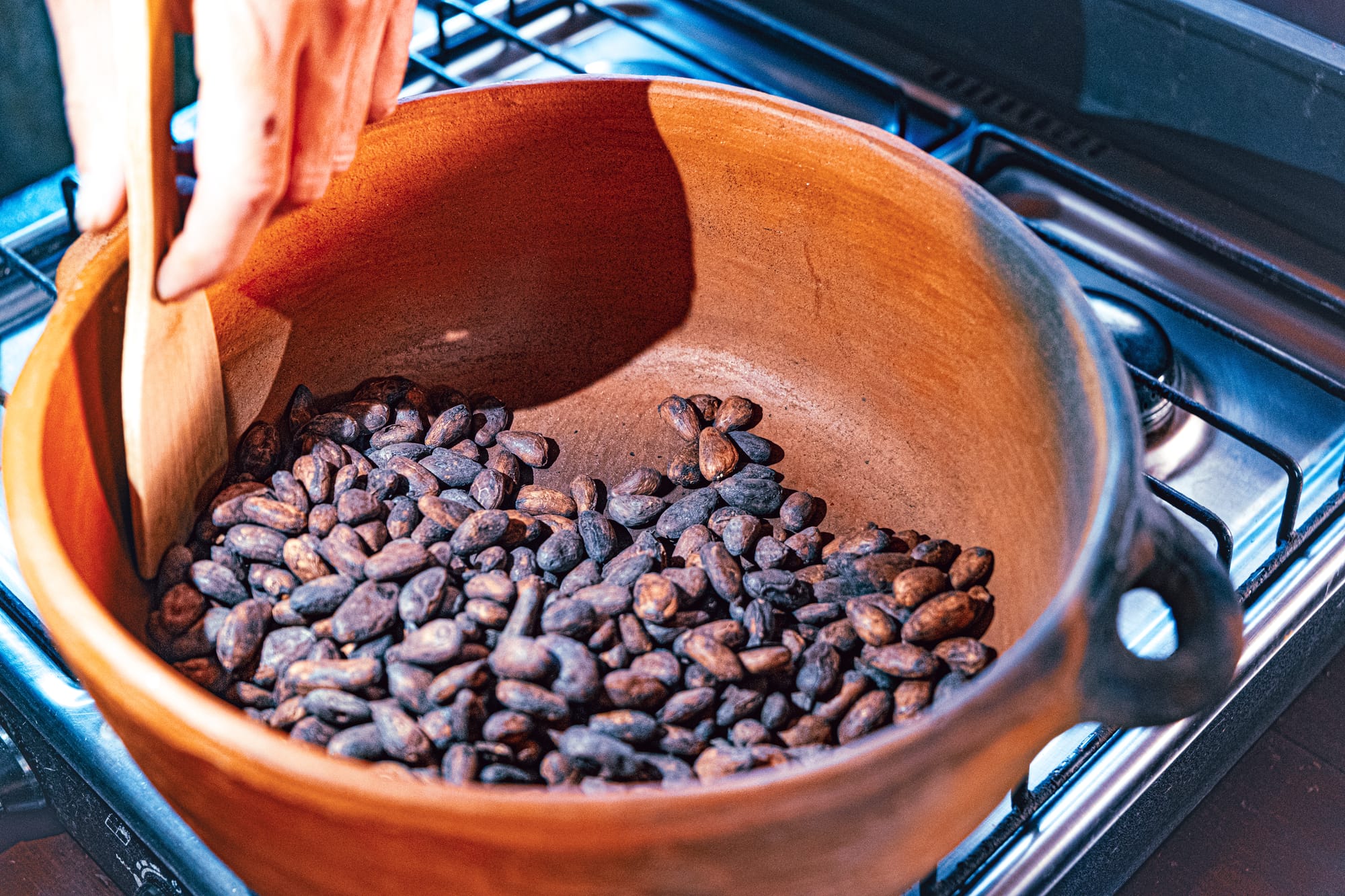 Roasting locally sourced Chiapas cacao beans over the stove during a cacao workshop in San Cristóbal de las Casas