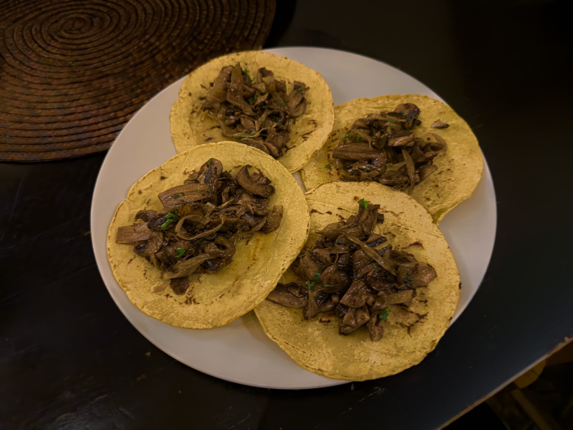 A plate of vegan mushroom tacos from La Charcu in San Cristóbal de las Casas, with sautéed mushrooms and onions on warm corn tortillas