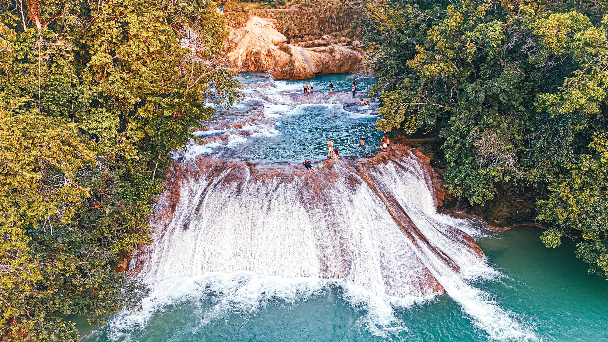 Cascadas Roberto Barrios waterfalls near Palenque, Chiapas, Mexico, wide stepped waterfall with turquoise pools, people swimming and standing on limestone cascades, jungle waterfalls near Palenque, Roberto Barrios natural swimming pools day trip