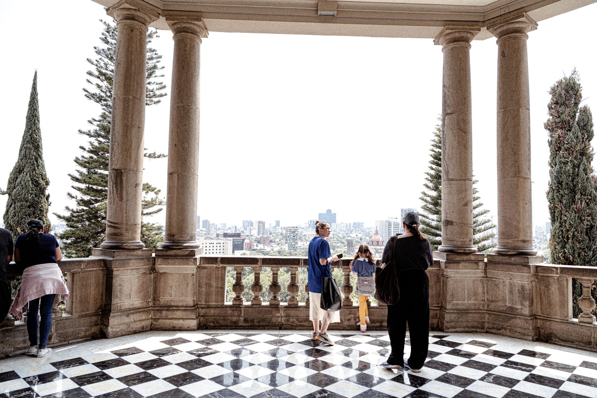Chapultepec Castle Mexico City terrace with visitors overlooking skyline and checkered floors