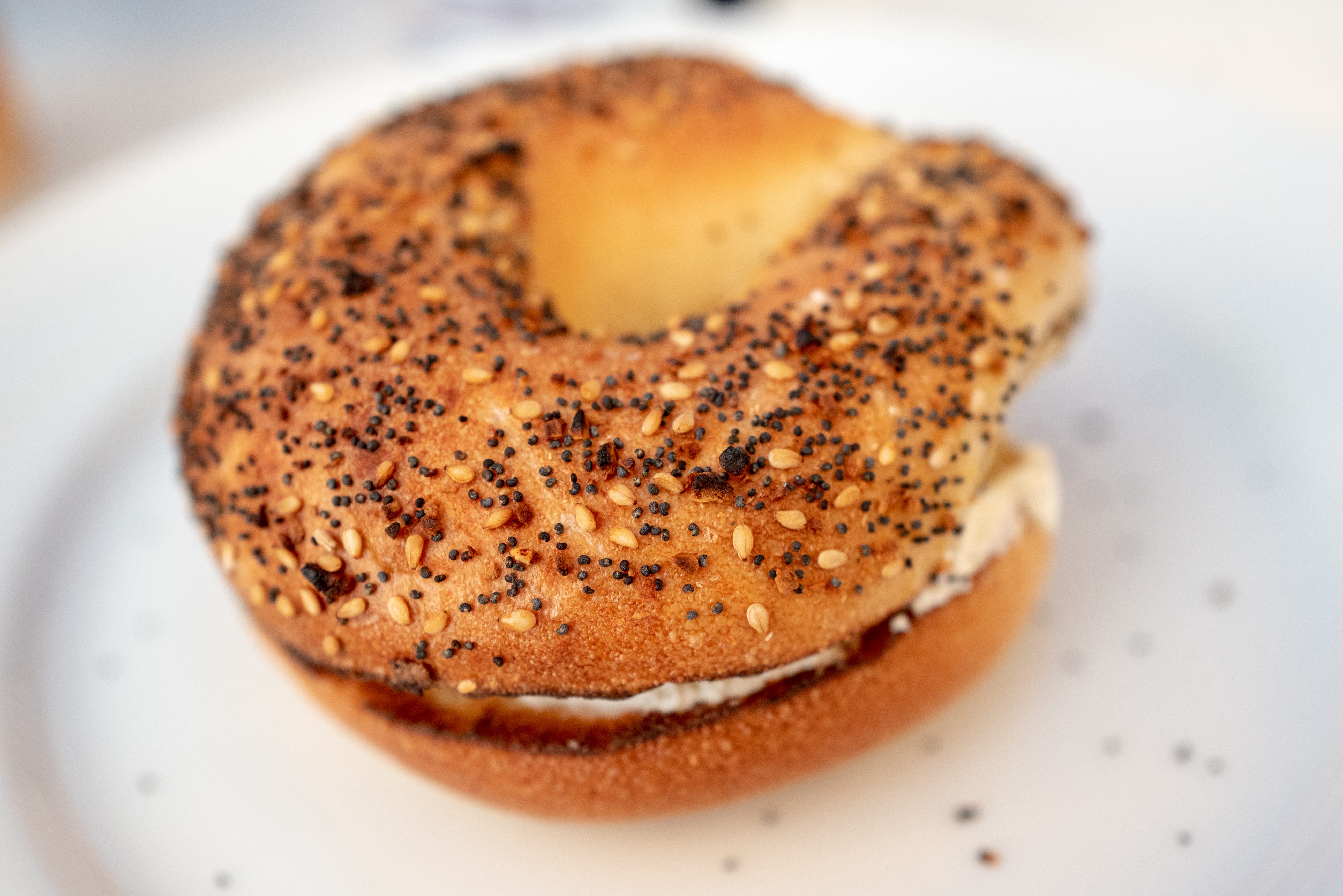 An Eggything bagel on a white plate.