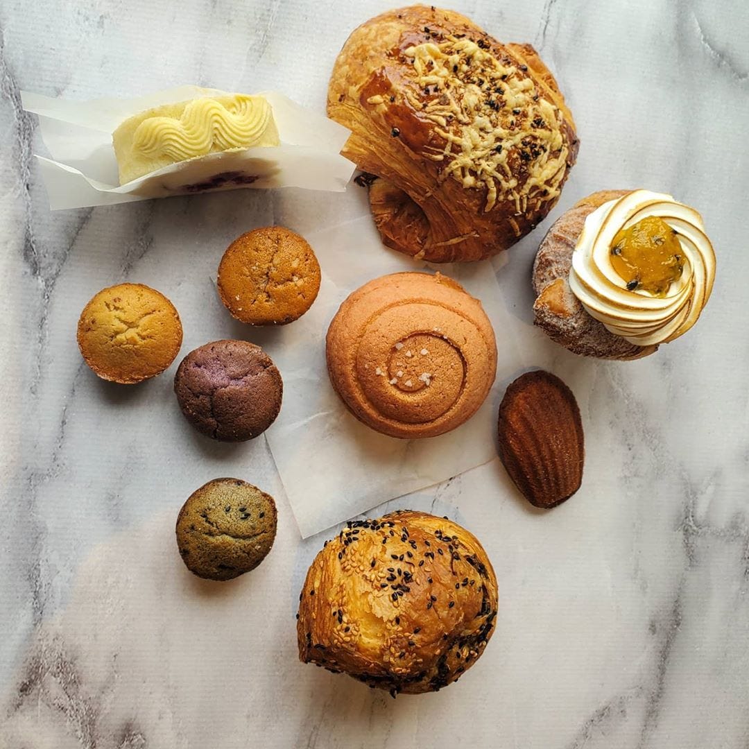 A variety of pastries arranged on a marble surface.