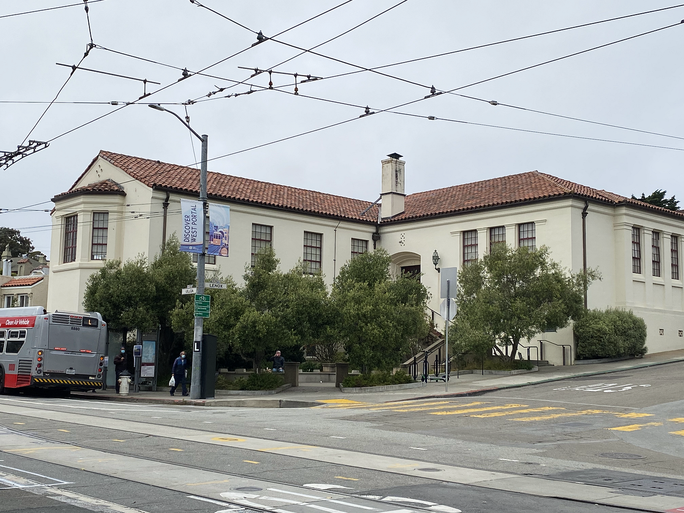 A view of the exterior of the West Portal Library, taken from the intersection of Lenox Way and Ulloa Street.