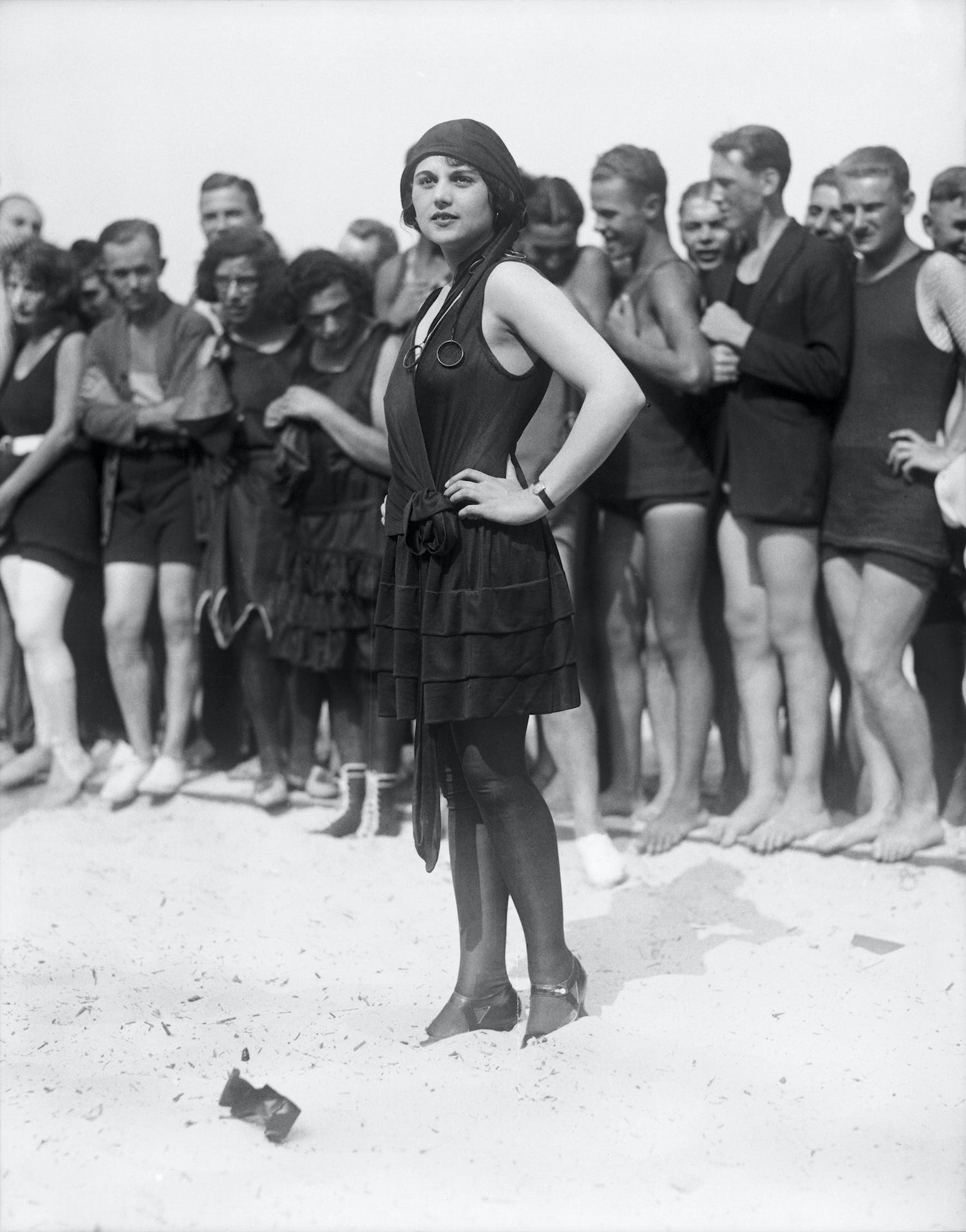 Vintage photo of Miss San Francisco with a crowd of people in bathing suits behind her.