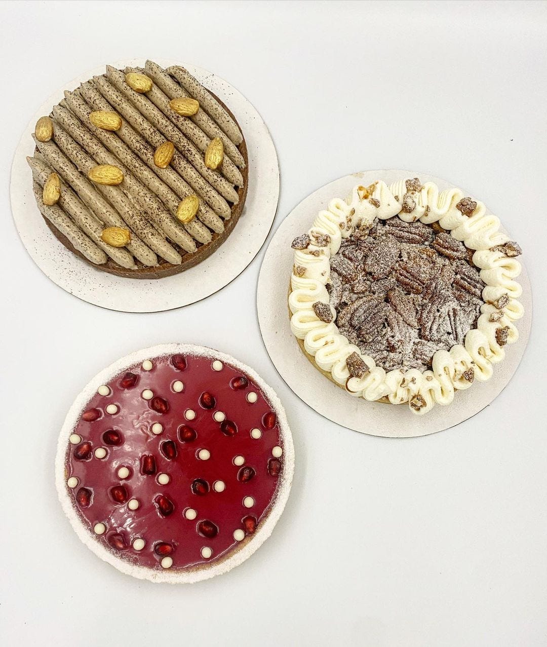 3 small, neatly decorated tarts.