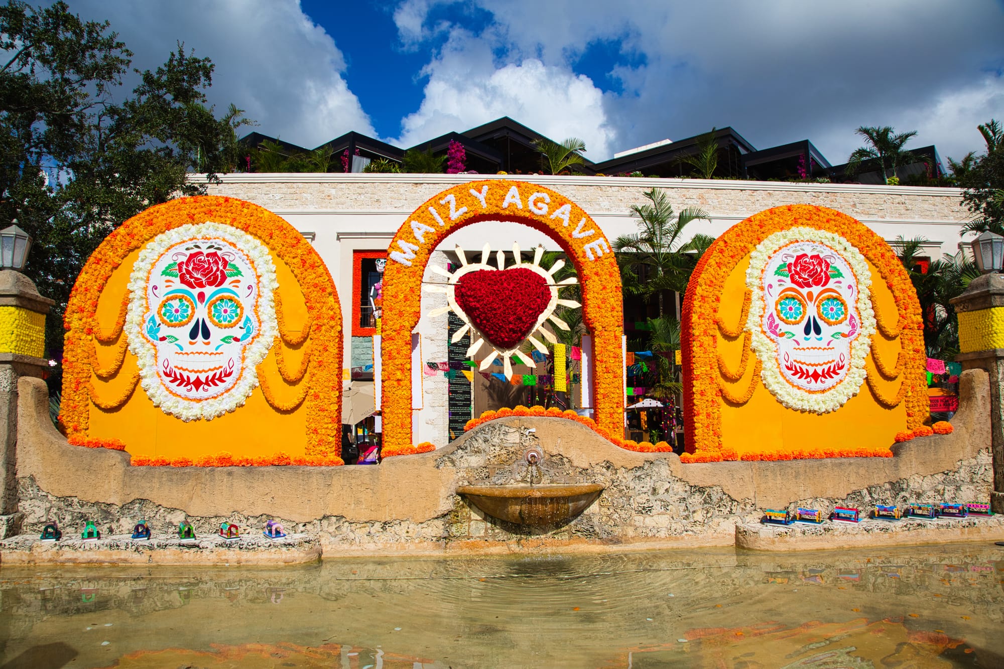 Orange and red colors with Mexican stylyized skulls on the back of an alter to the dead (think Coco). It'a s form of remebering those who passed away.