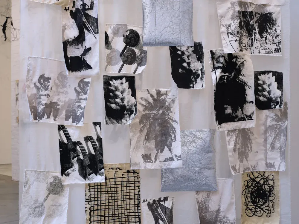 Textile installation of stitched fabric panels printed with black-and-white photographic imagery in an SVA MFA exhibition.