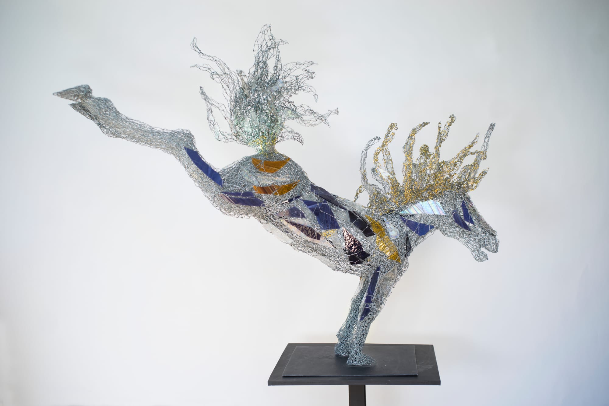 a glass sculpture of a horse balancing on its front legs