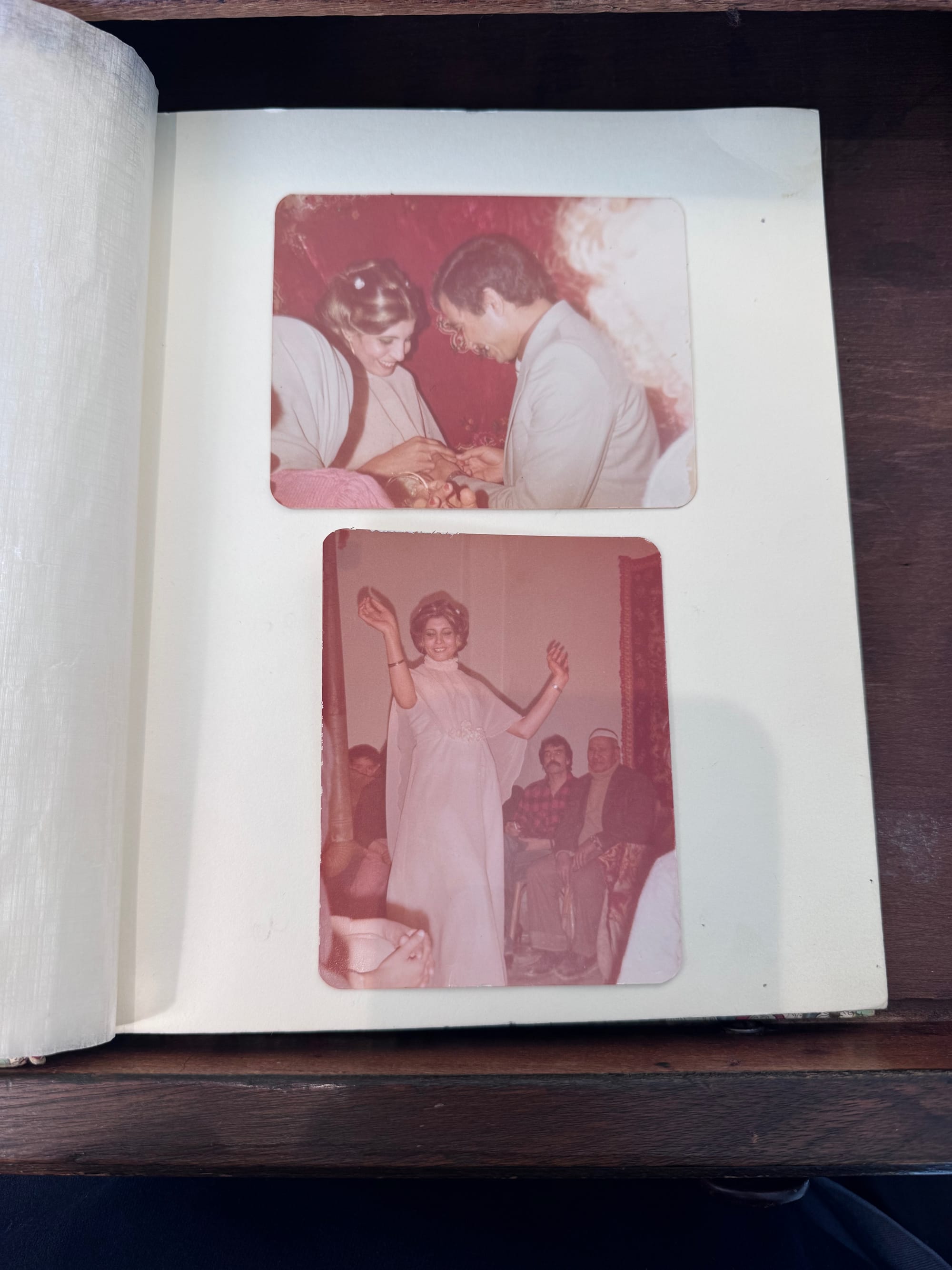 Photo album page with two images, one of a couple exchanging rings and another of a woman dancing in front of seated guests.