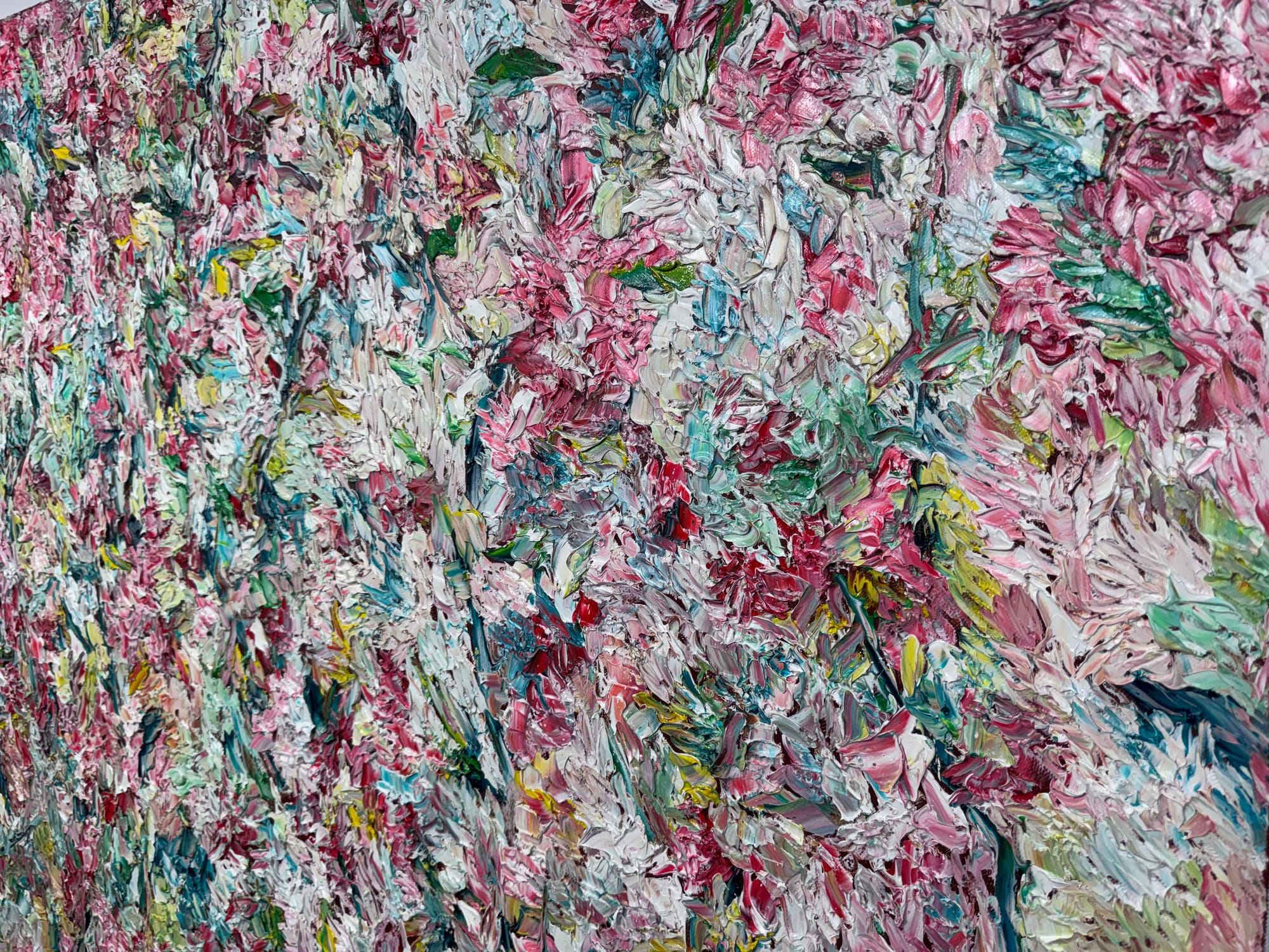 Close-up of a heavily textured painting with thick layers of pink, white and green paint forming dense, abstract floral shapes.