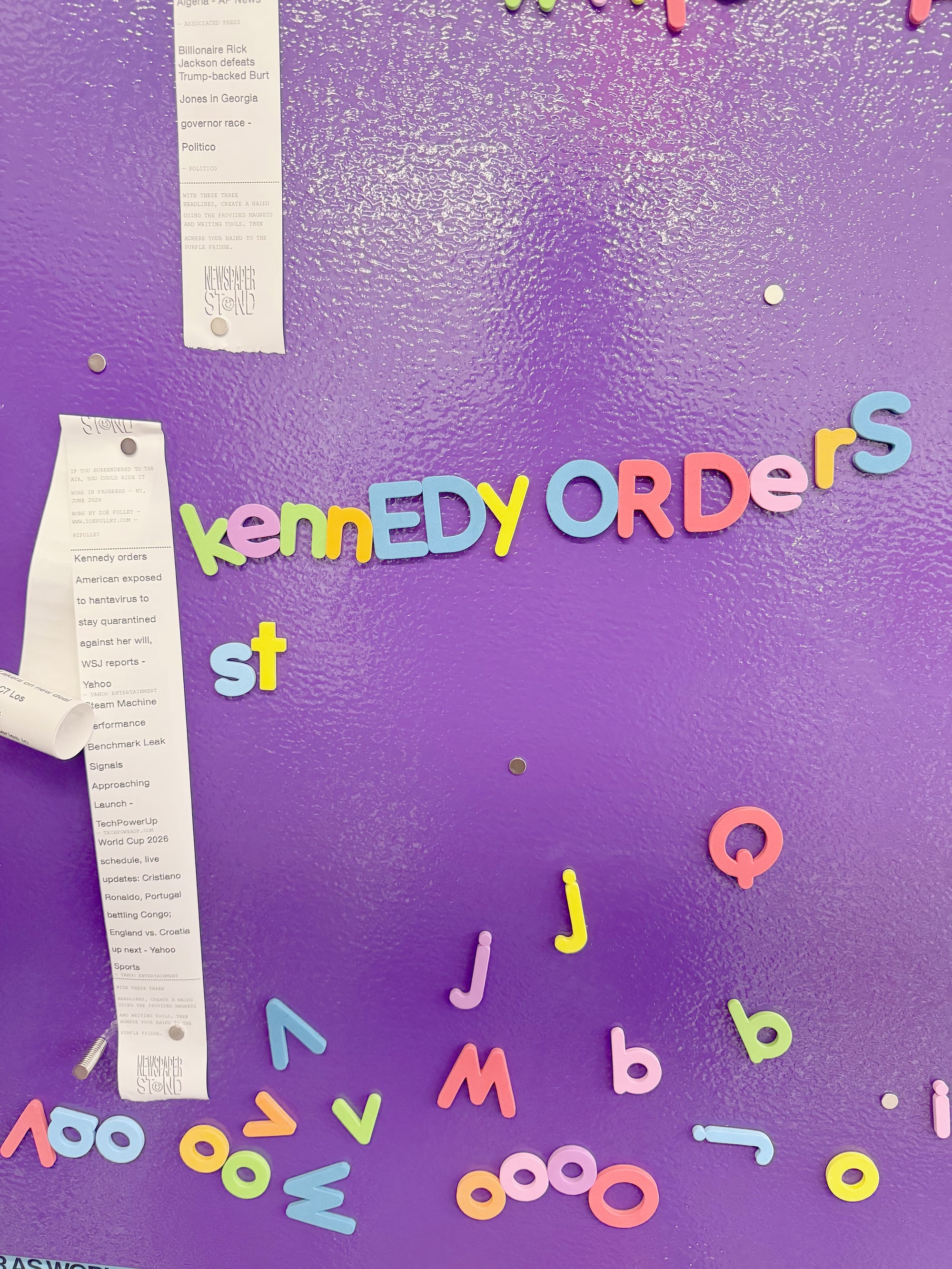 Children's magnetic letters spell out the words Kennedy Orders against a purple background