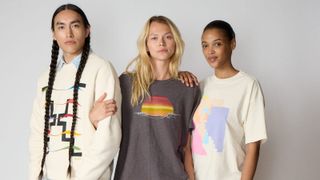 Three models wearing Hosh graphic T-shirts and denim jeans, showcasing artist-designed apparel from the Indigenous-led fashion brand.