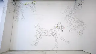 Wire sculpture of galloping horses suspended across a white gallery wall in an SVA MFA exhibition.