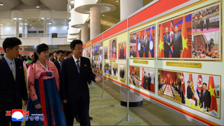 Visitors attend a photo exhibit celebrating Kim Jong Un