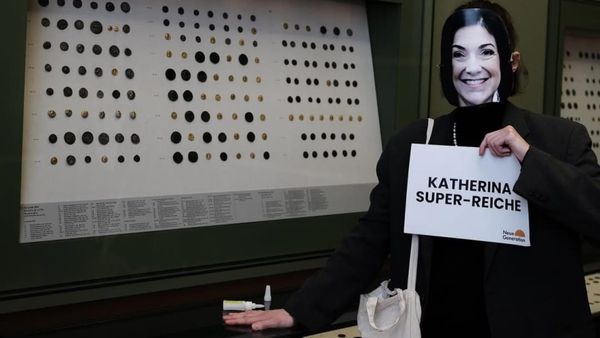 A New Generation protester is seen in an Instagram post wearing a mask and supergluing herself to a display case at the Bode Museum in Berlin