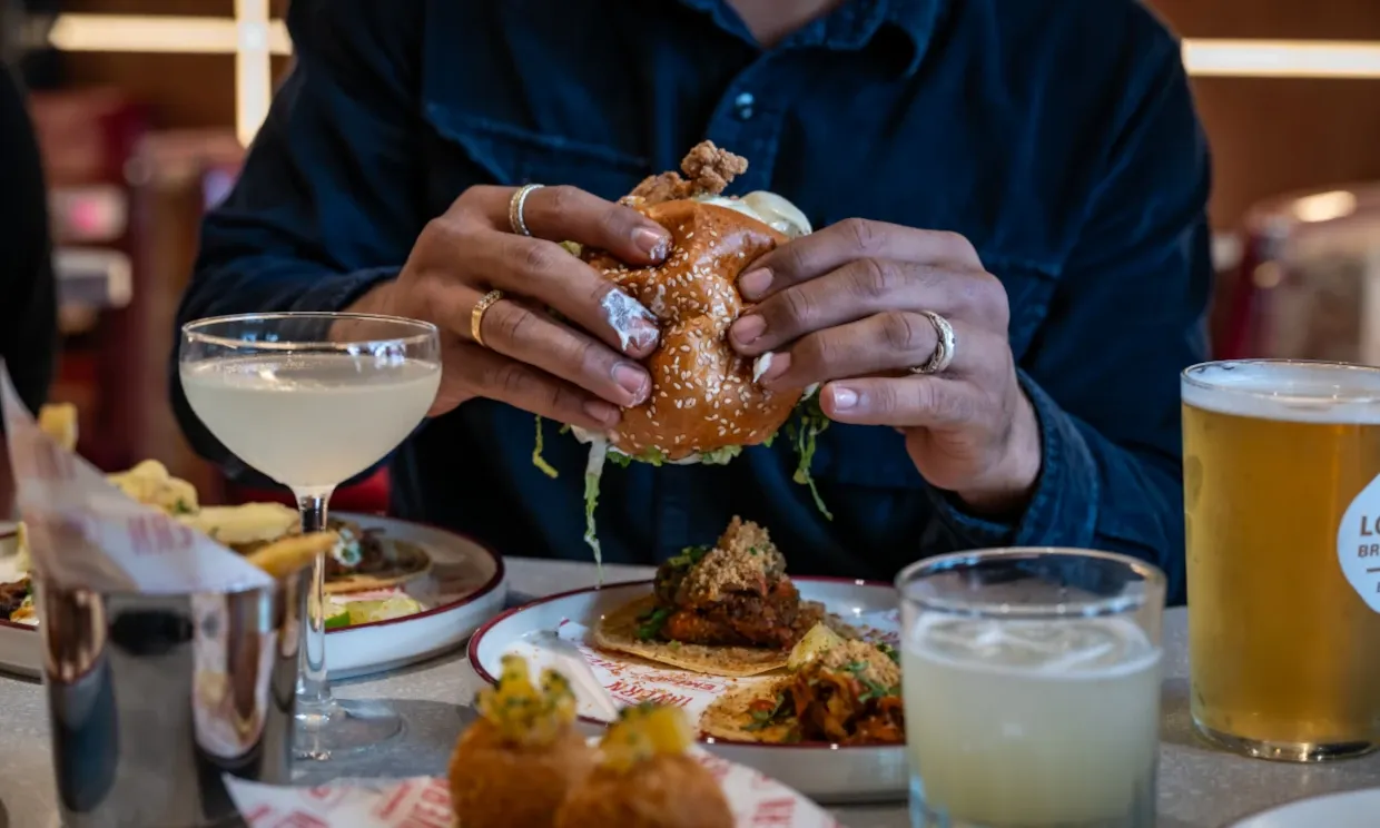 A customer enjoying cocktails with their meal.