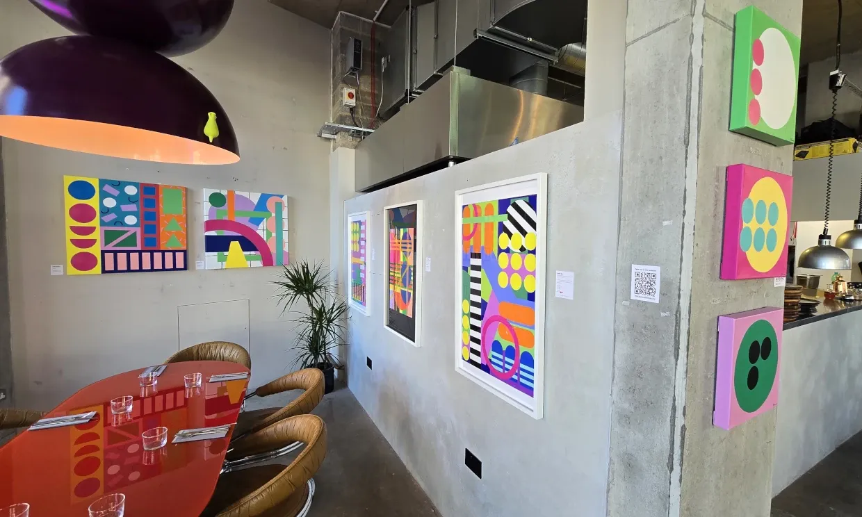 Colourful artwork adorns a restaurant wall. 